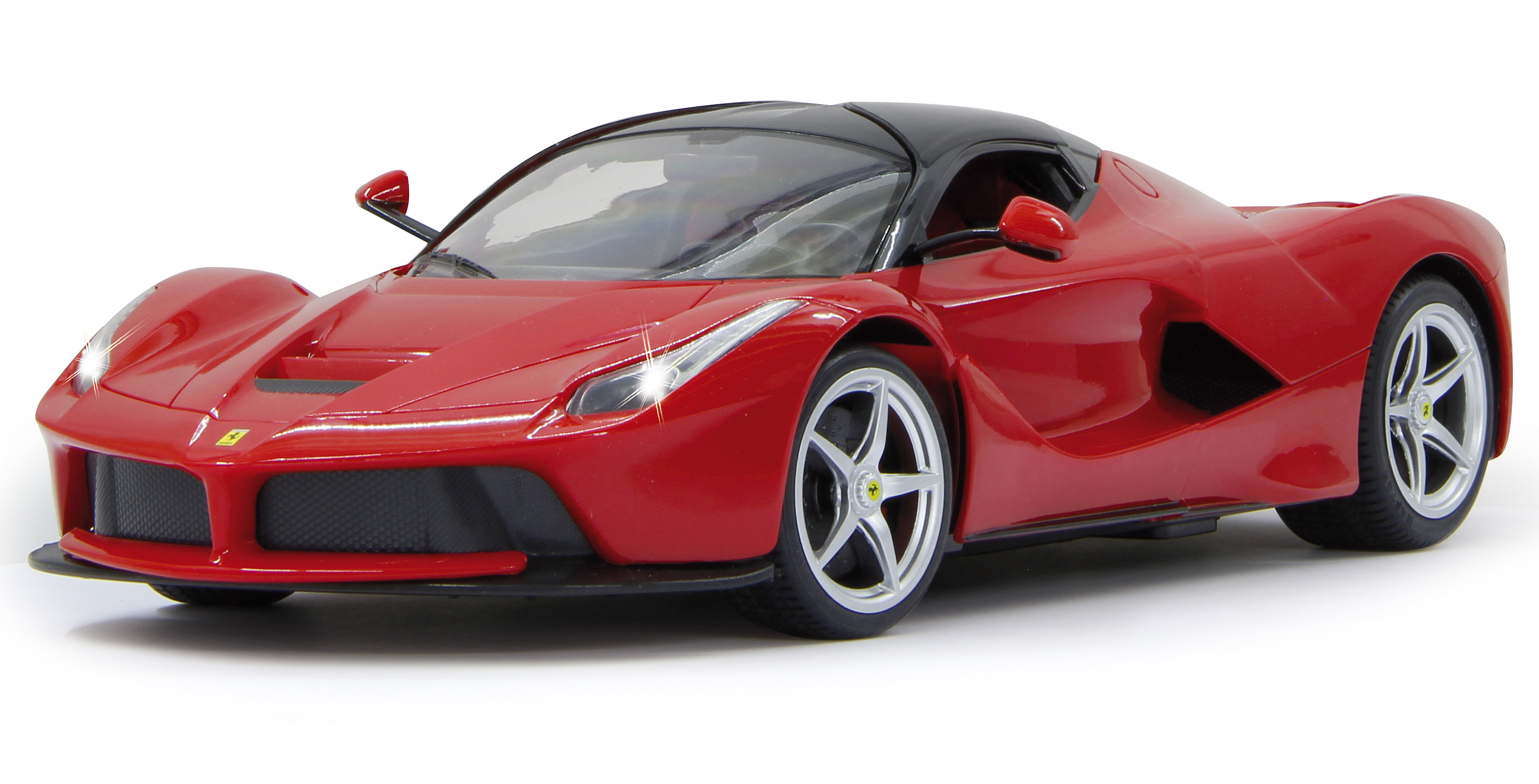 A red Ferrari model car with headlights on a white surface.