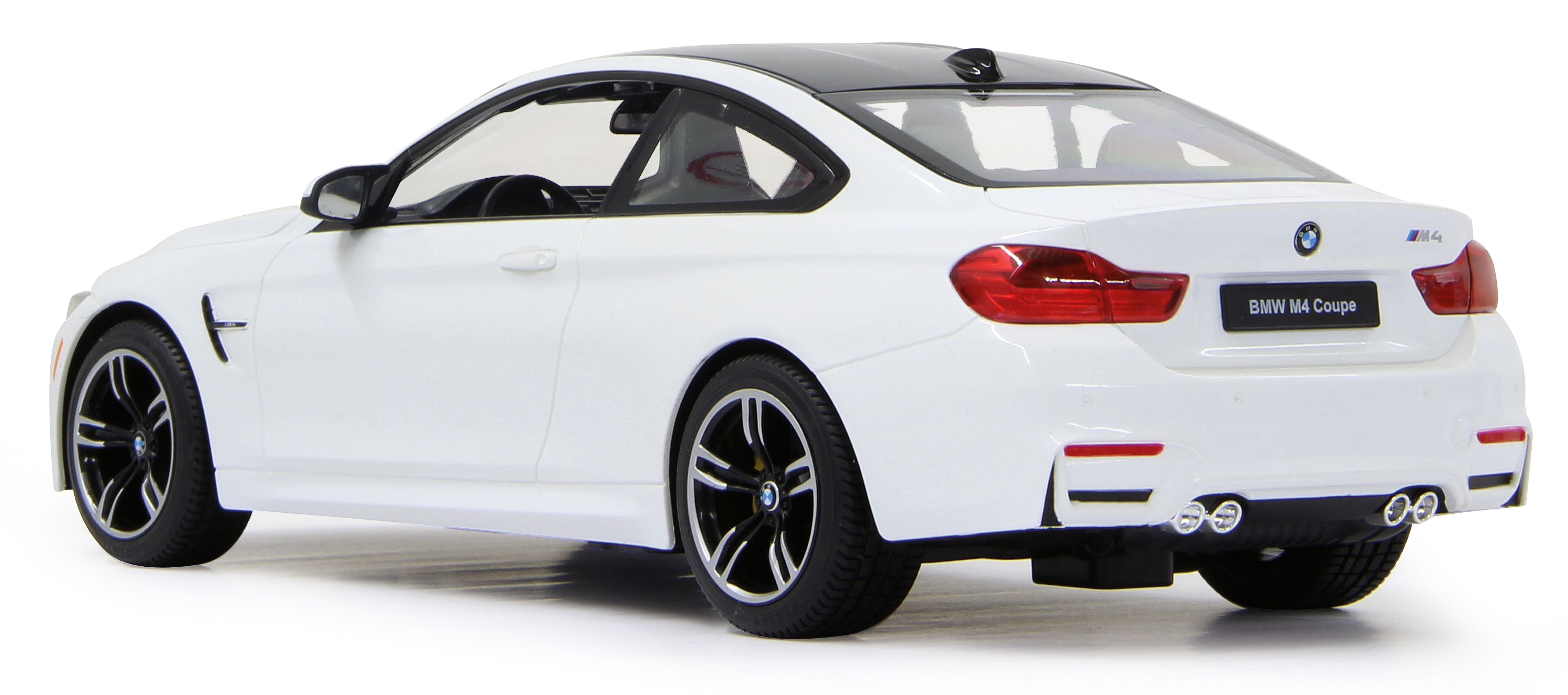 Back view of a white BMW M4 Coupe with a black roof, showing rear lights and wheels.