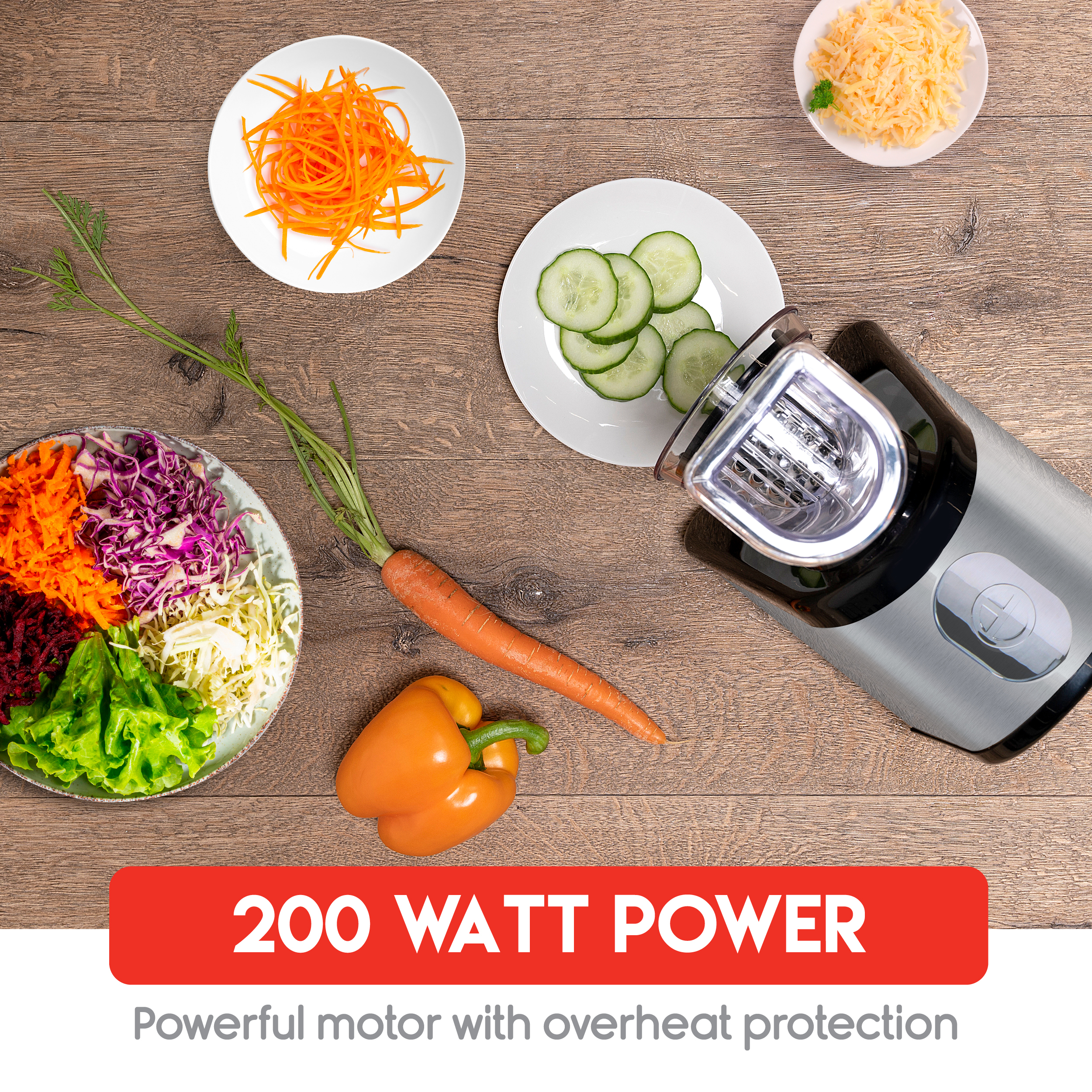 A food processor with plates of vegetables, carrot, and pepper on a wooden surface. Text reads '200 WATT POWER'.