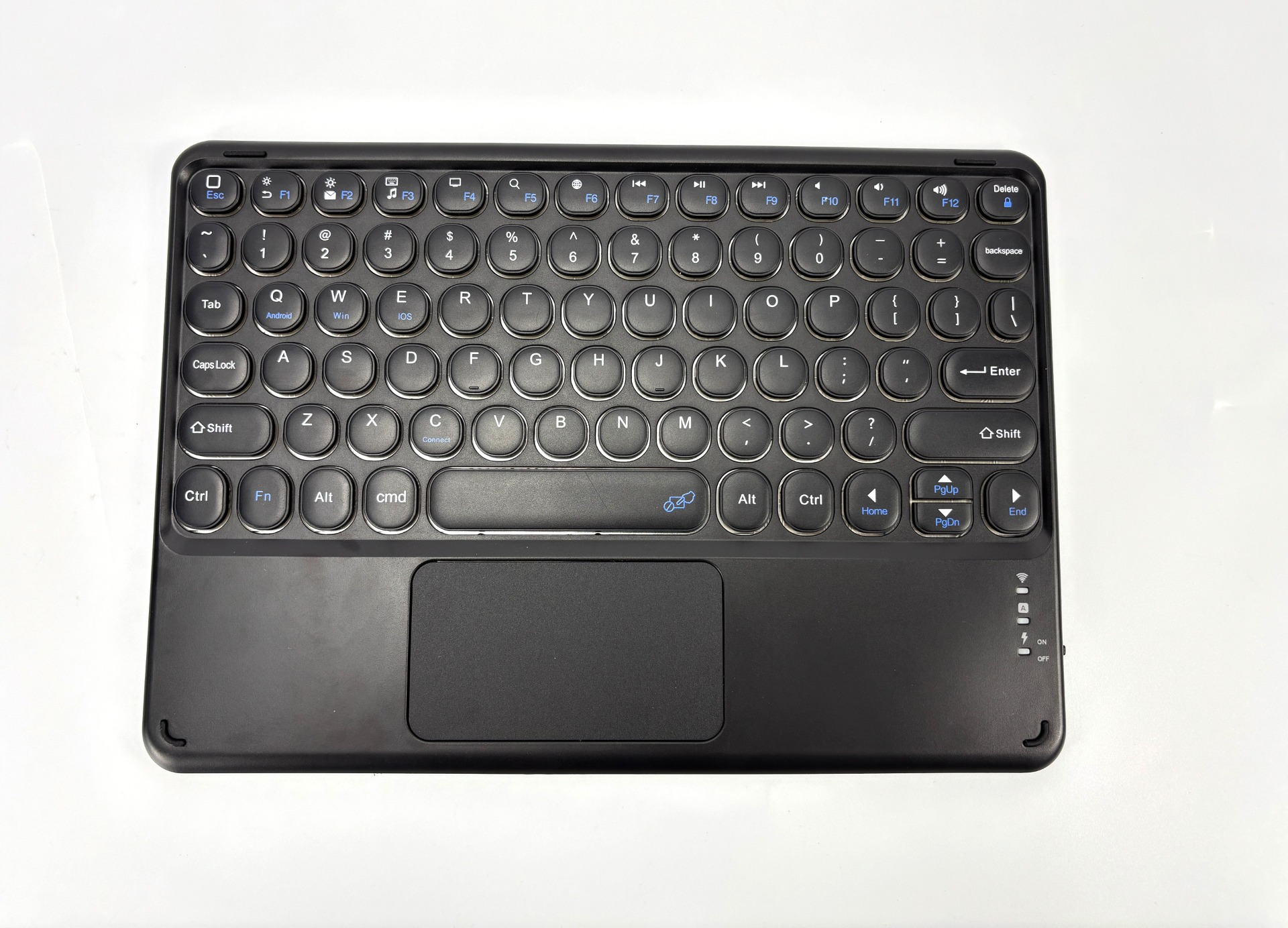 A black keyboard with a trackpad is centered on a white background.