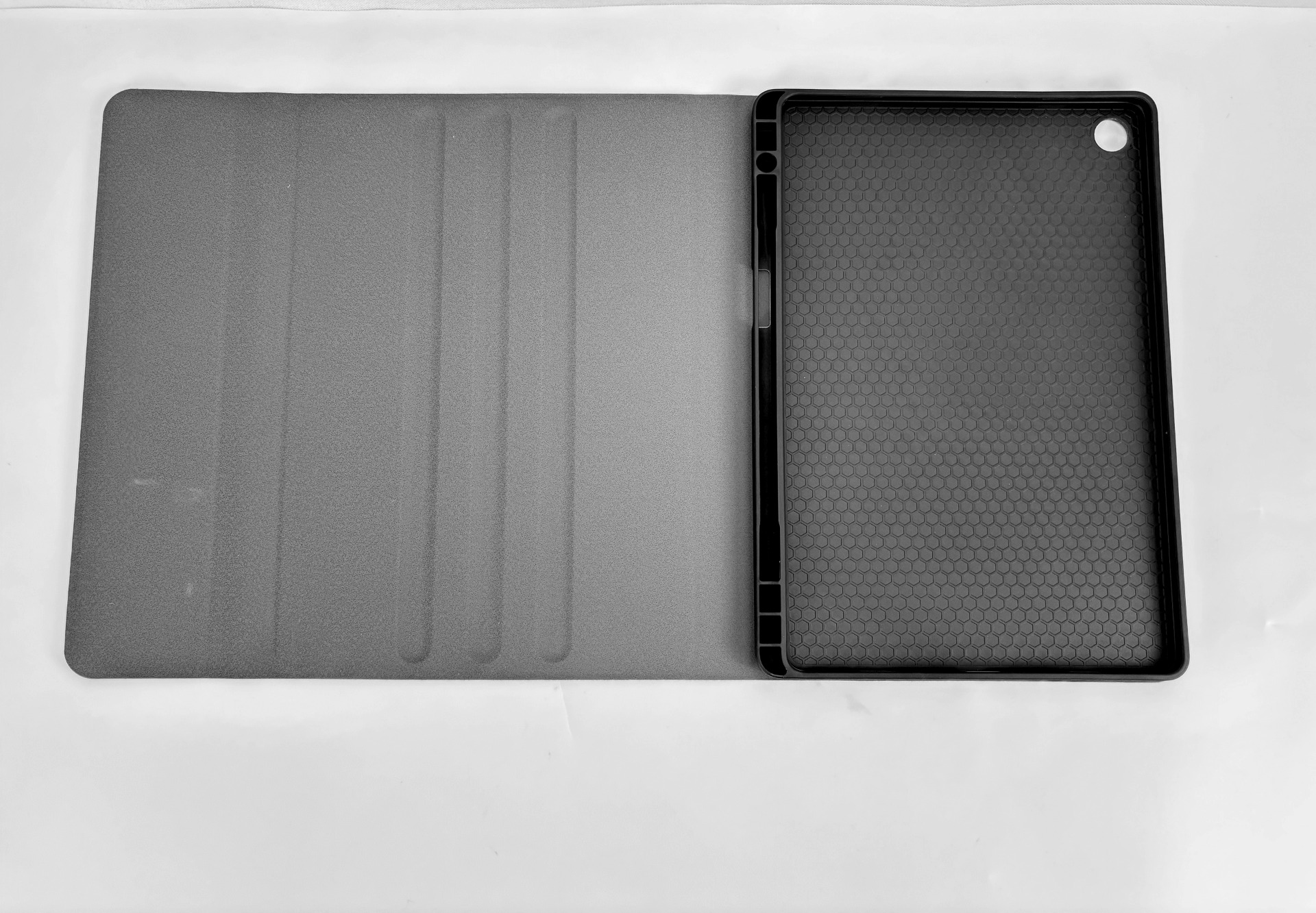 Open tablet case, showing a gray cover and the black interior holding the tablet.