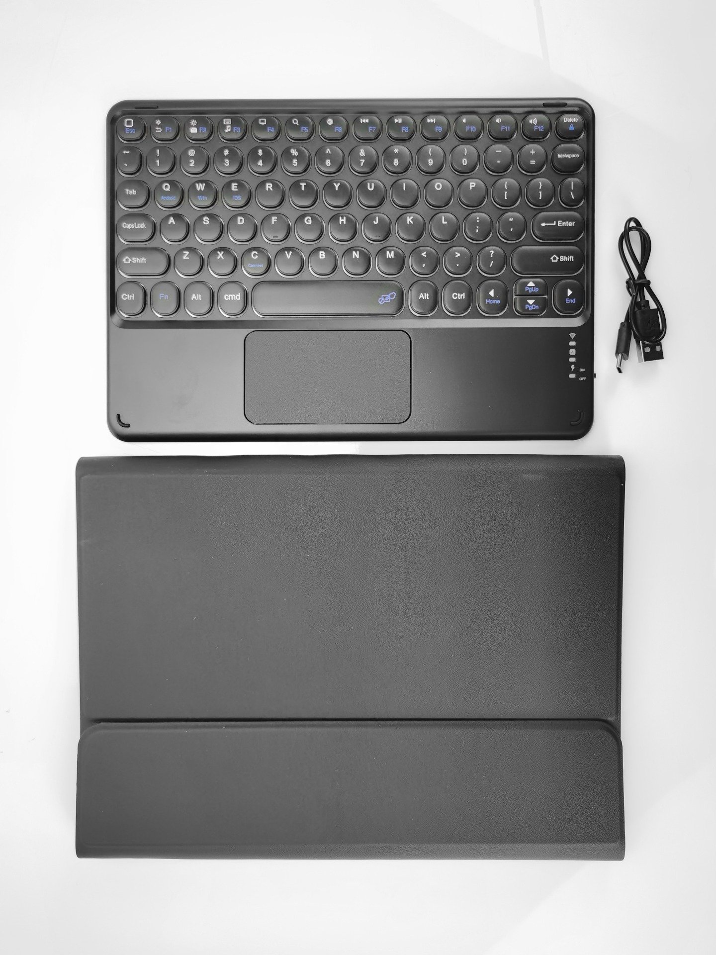 A black keyboard with a touchpad and a separate black case.