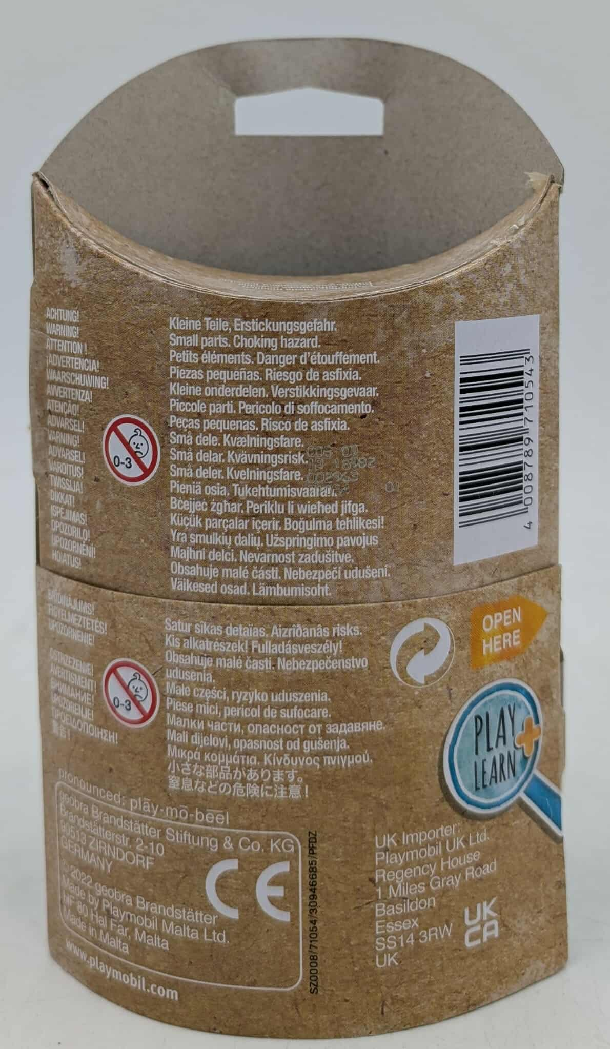Spielzeugverpackung mit Warnungen in mehreren Sprachen. Warnung vor Kleinteilen und mehr.
