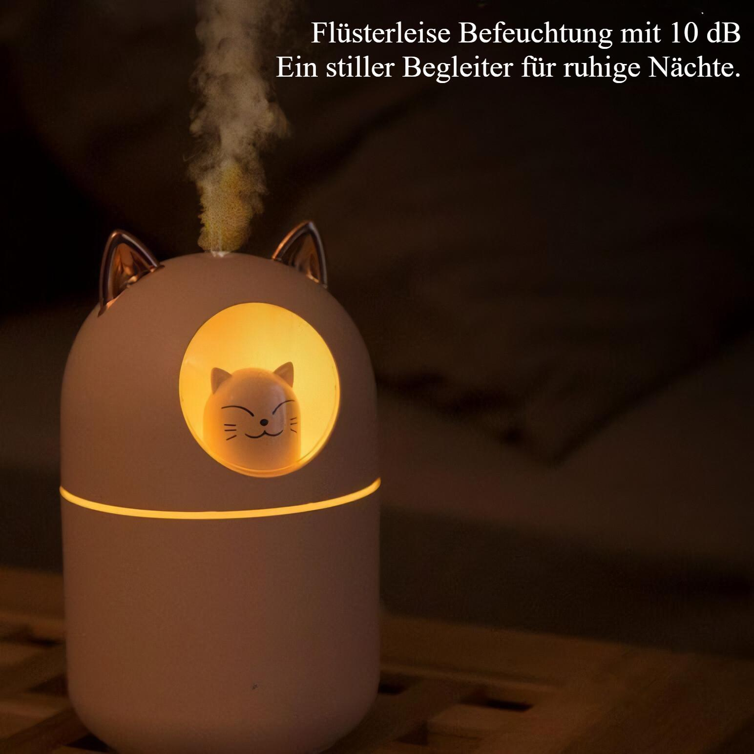 Katzenförmiger Luftbefeuchter mit beleuchtetem Innenraum und Dampf auf Holz.