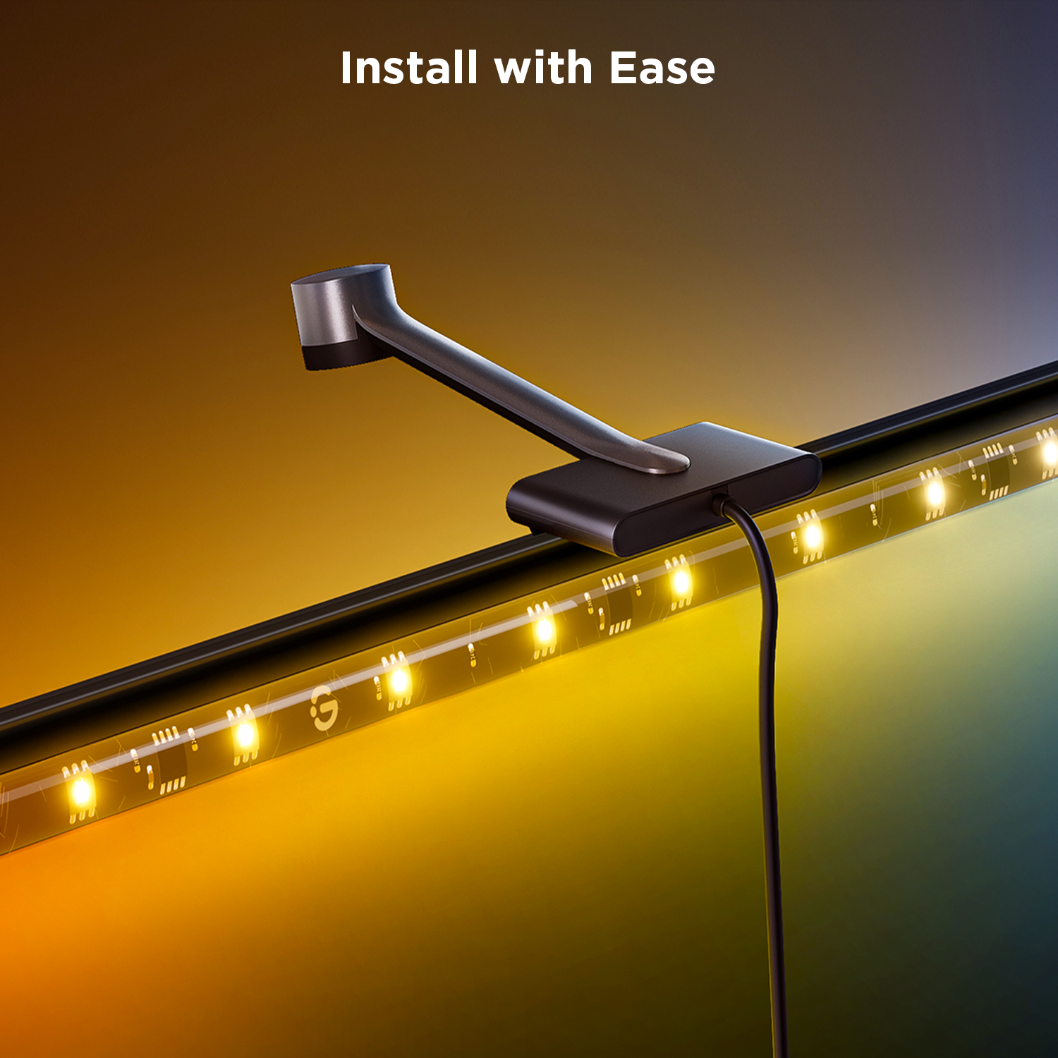 Czarny pasek świetlny z zaciskiem i przewodem zasilającym, zainstalowany na monitorze, z żółtymi światłami.