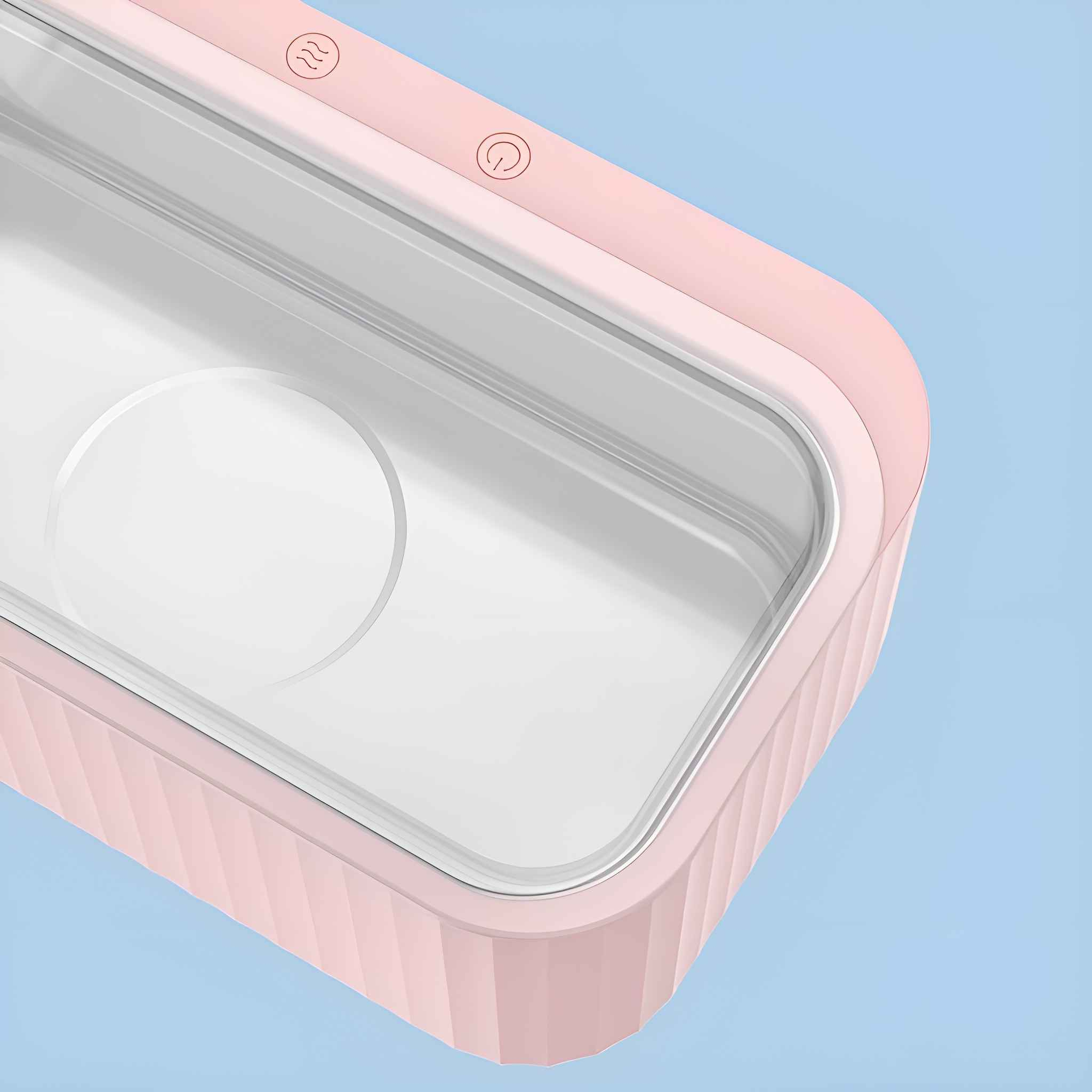 Eine Nahaufnahme des Inneren eines rosa Ultraschallreinigers. Der Reinigungsbereich ist leer.