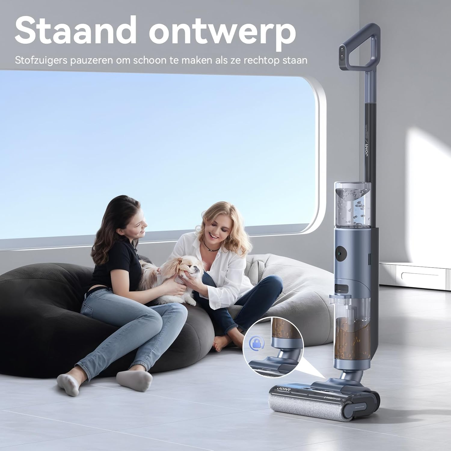Two women, one holding a dog, with a vacuum cleaner, in a modern living room setting.