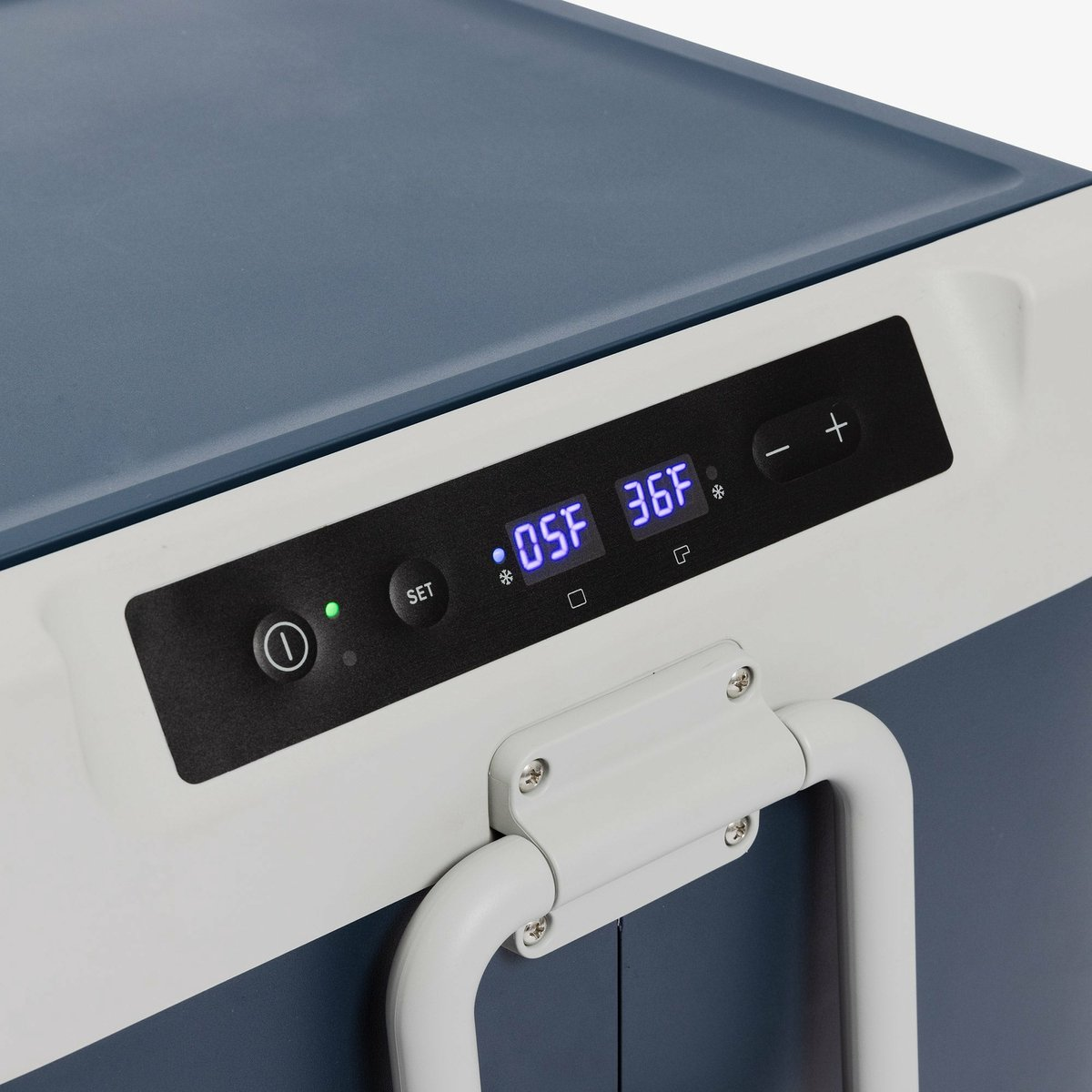 Close-up of a cooler's control panel. It shows a digital display and buttons for setting temperature.