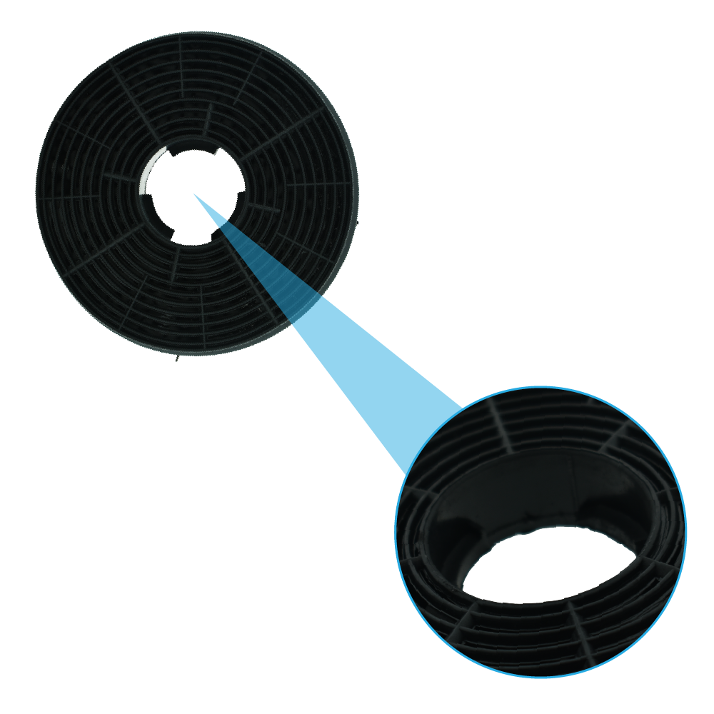 Close-up of a round, black cooker hood filter with a highlighted center and circular pattern.