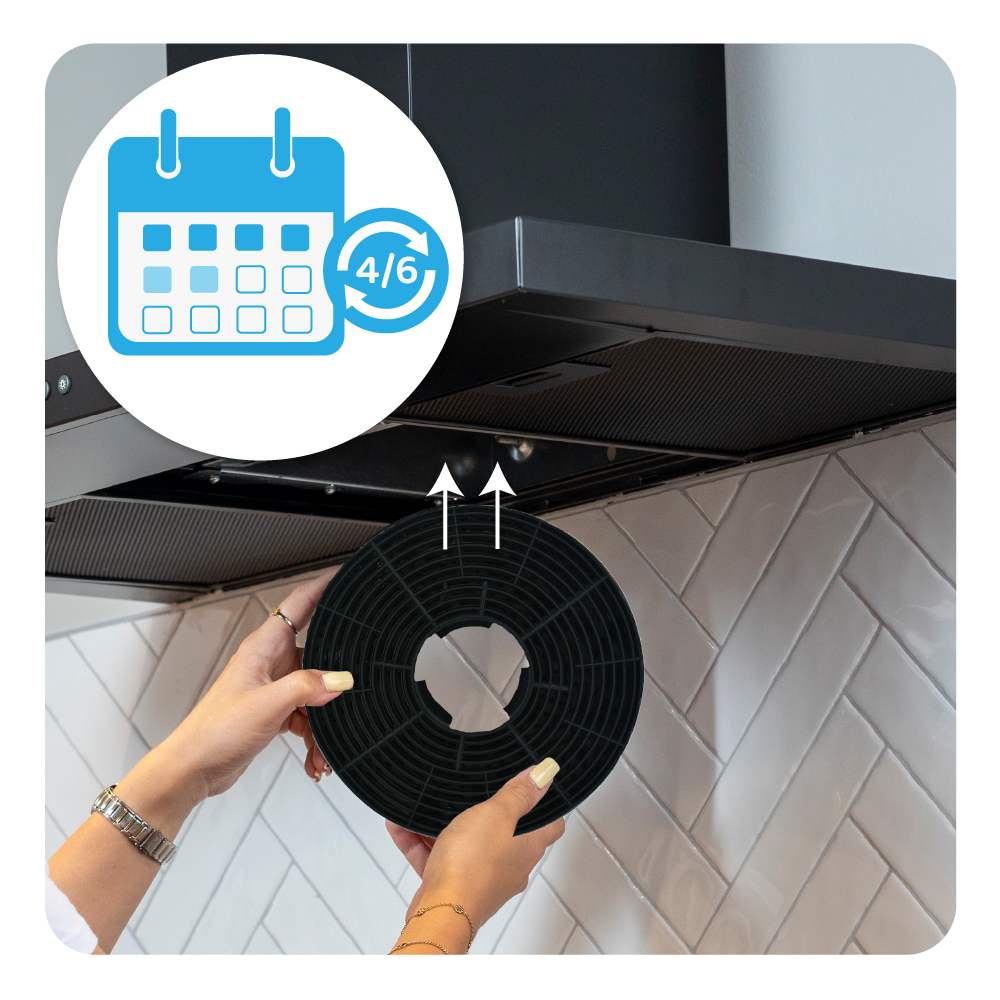 A person replaces a round, black filter under a cooker hood. A calendar icon is displayed.