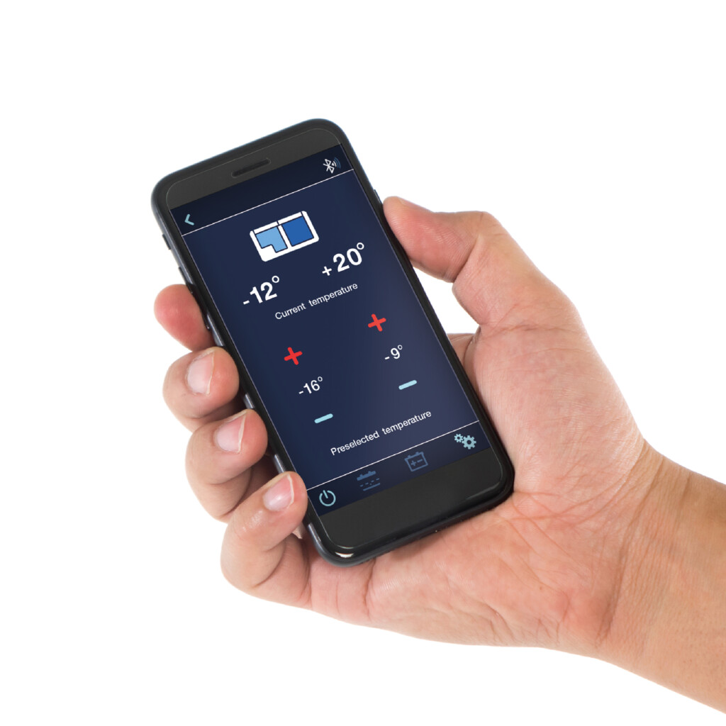 A hand holding a smartphone displaying a temperature control app interface.