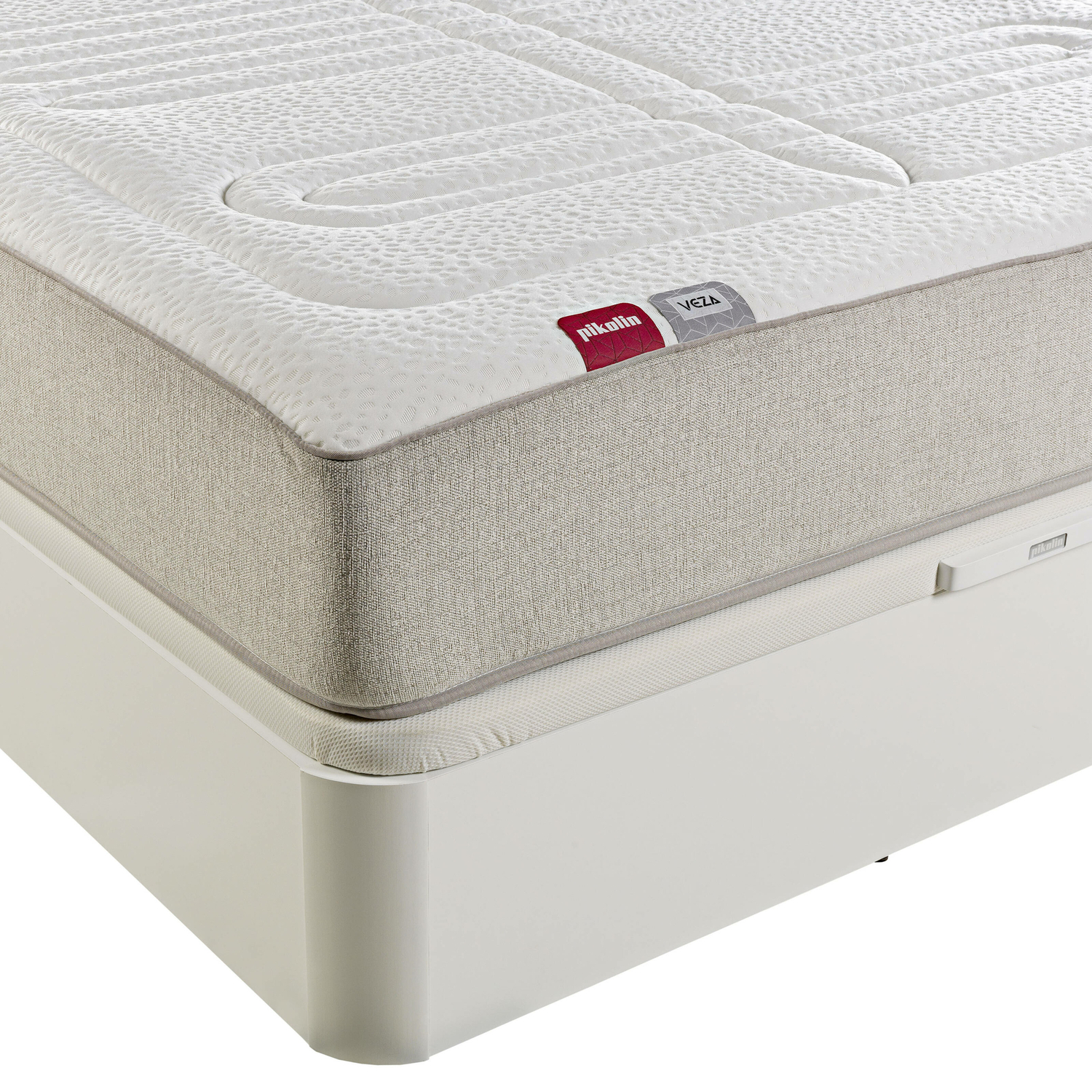 Colchón blanco con borde beige sobre base blanca. La parte superior tiene un patrón texturizado.