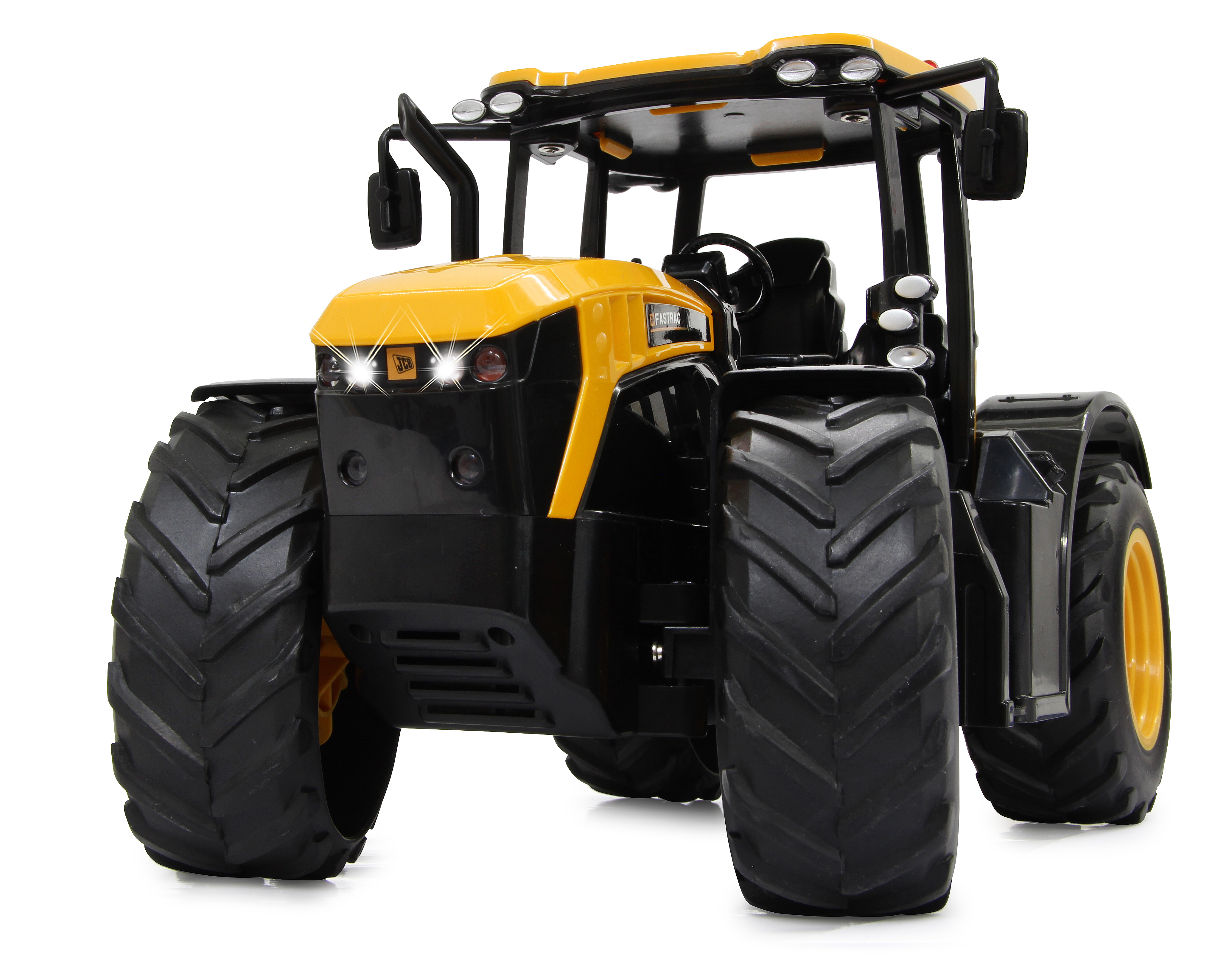 Spielzeugtraktor, gelb und schwarz, mit Lichtern. Der Traktor hat ein schwarzes Chassis. Weißer HG.