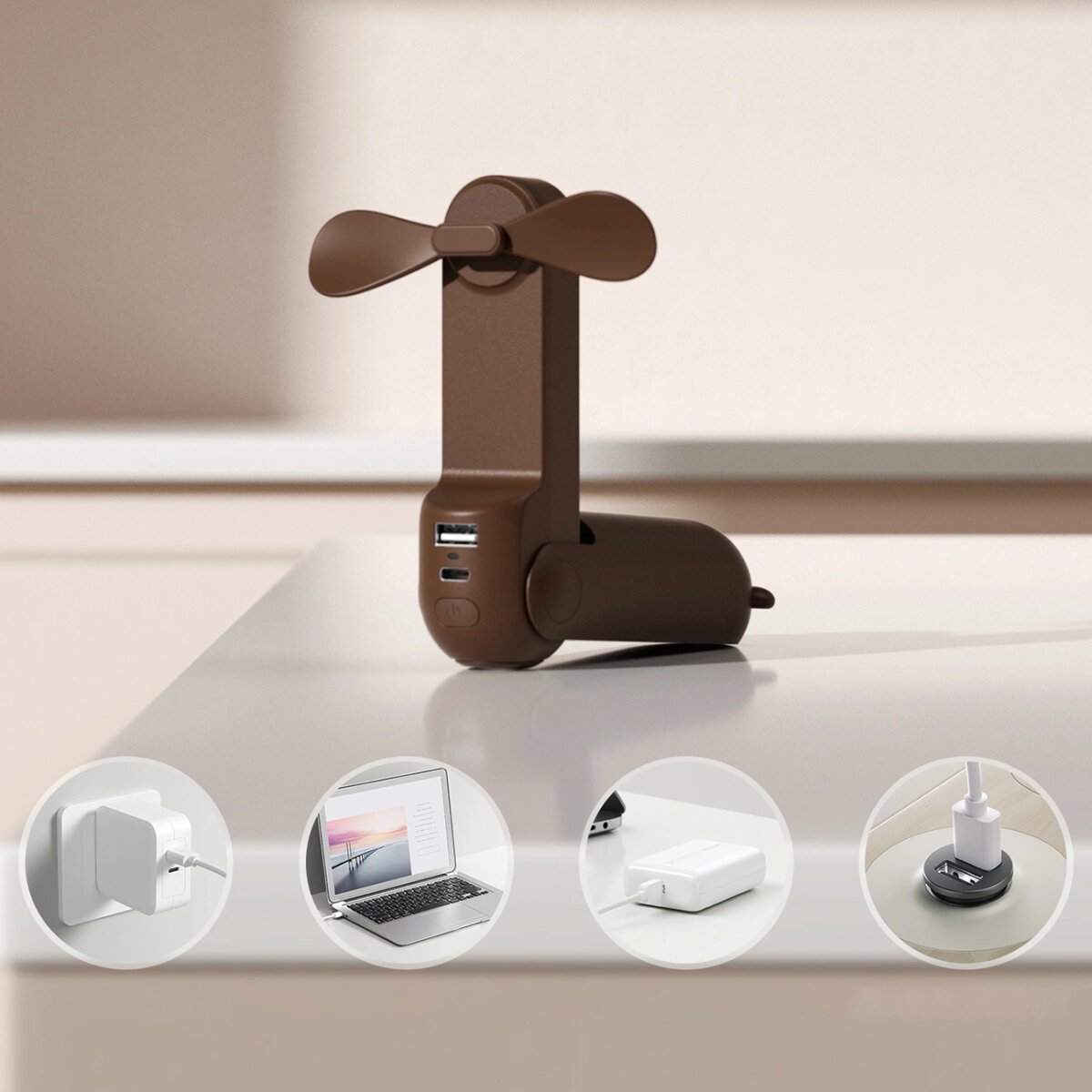 Brauner tragbarer Ventilator mit USB-Anschlüssen und Laptop, Ladegeräte in Kreisen auf einem Tisch.