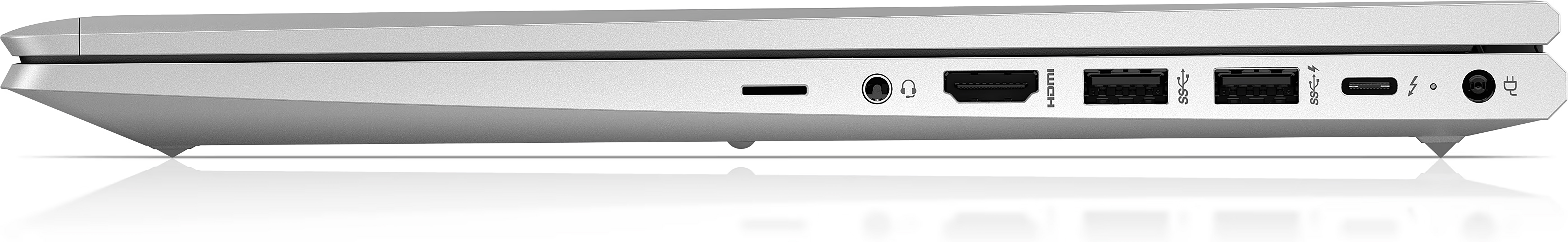 A silver laptop side view with ports. Includes a charging port, USB, HDMI, and headphone jack. The surface is reflective.