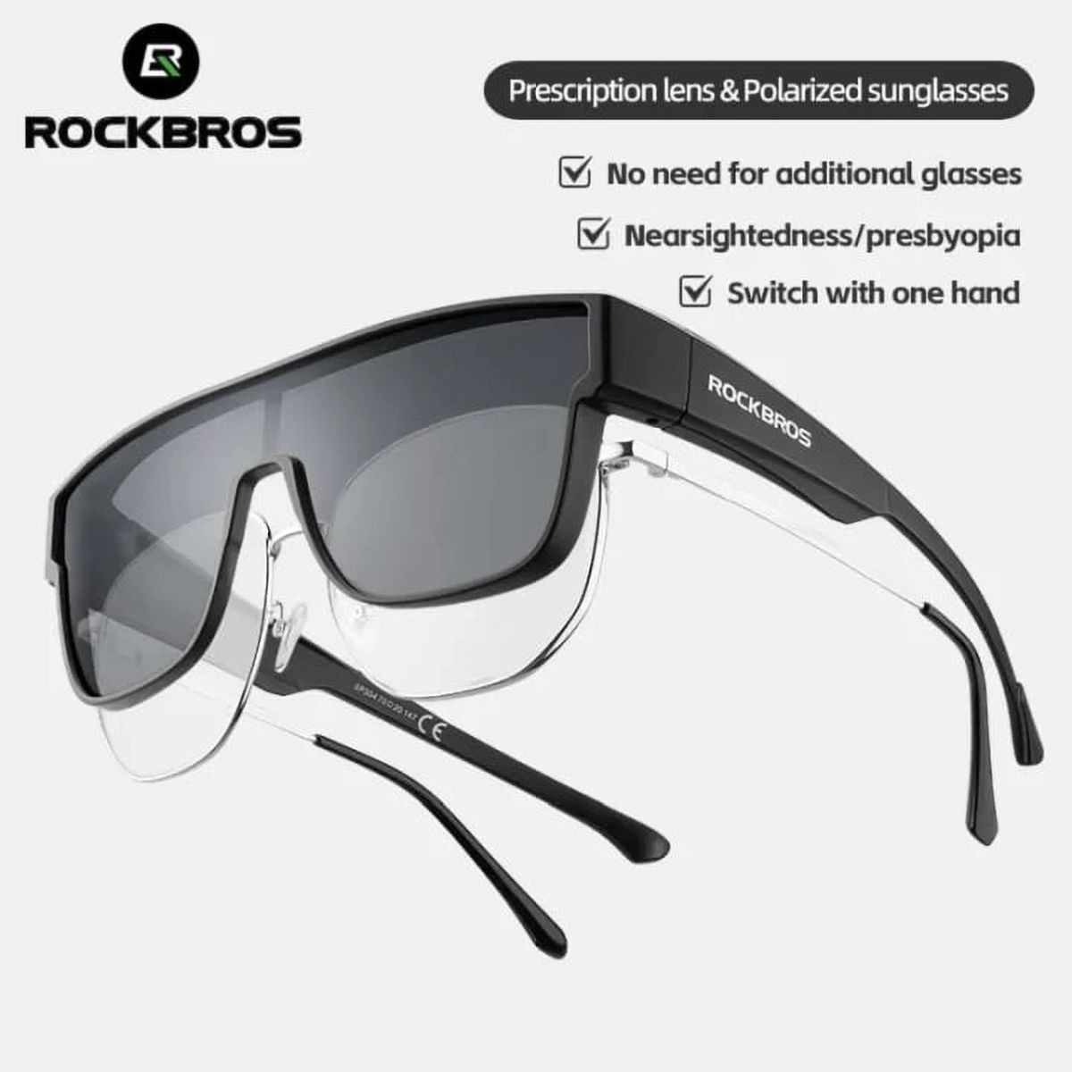Schwarze Sonnenbrille mit klaren unteren Gläsern und dem Text 'ROCKBROS'. Der Hintergrund ist weiß.