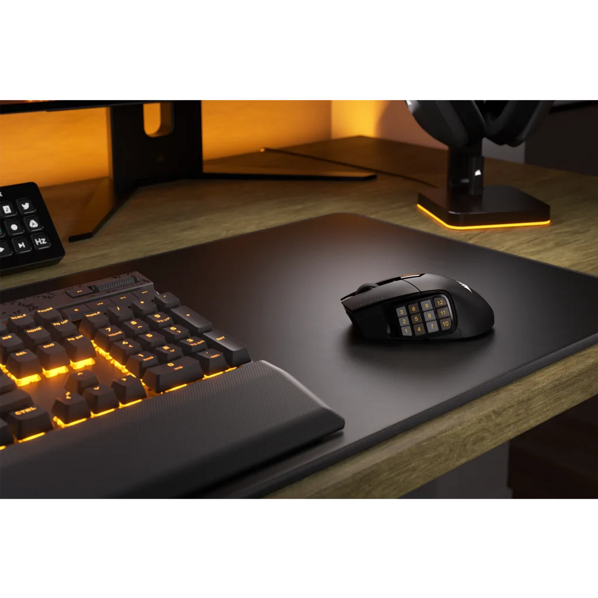 A gaming setup with a keyboard, mouse, and mousepad. The keyboard has orange lighting.