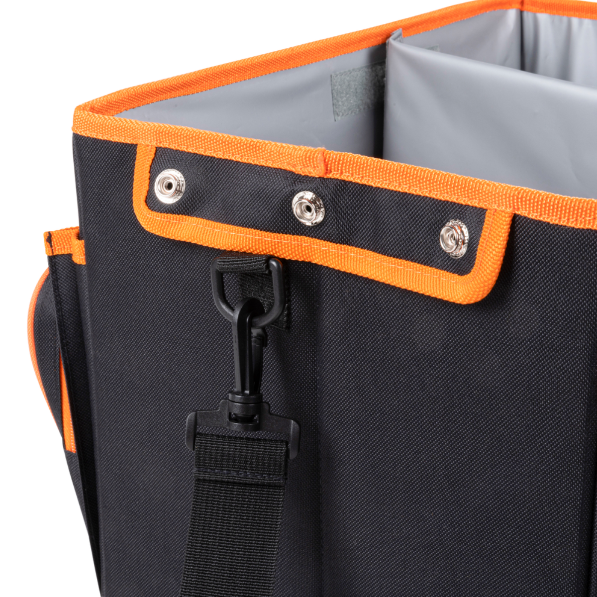 Close-up van een zwarte en oranje auto-organizer. Metalen klinknagels en zwarte riem zichtbaar.