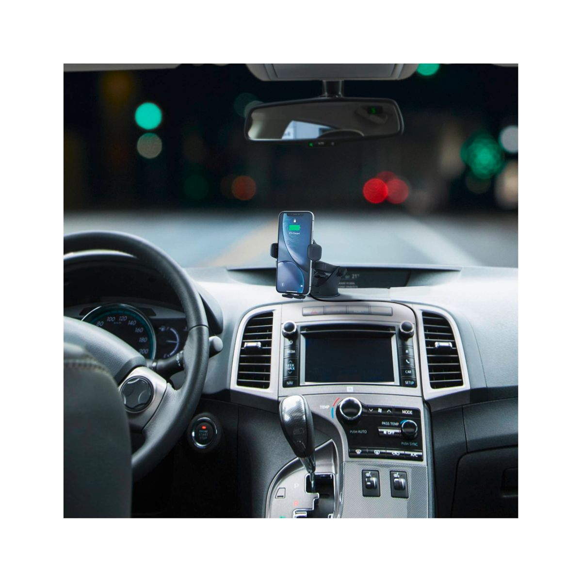 Ein Auto-Innenraum mit einem Telefon, das auf dem Armaturenbrett montiert ist. Das Telefon ist in einer Halterung.