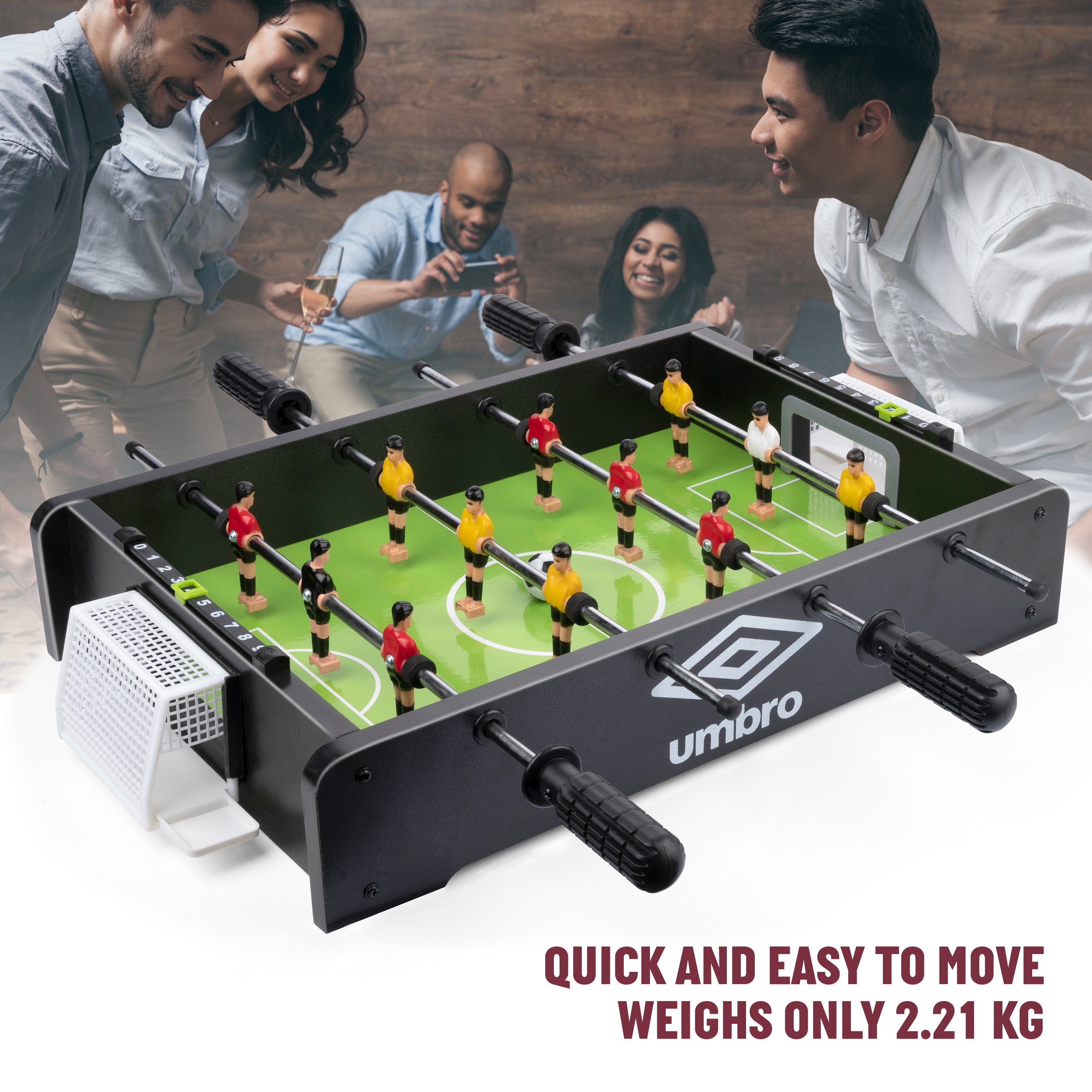 People enjoying a foosball table with red and yellow players, set against a blurred background of friends.