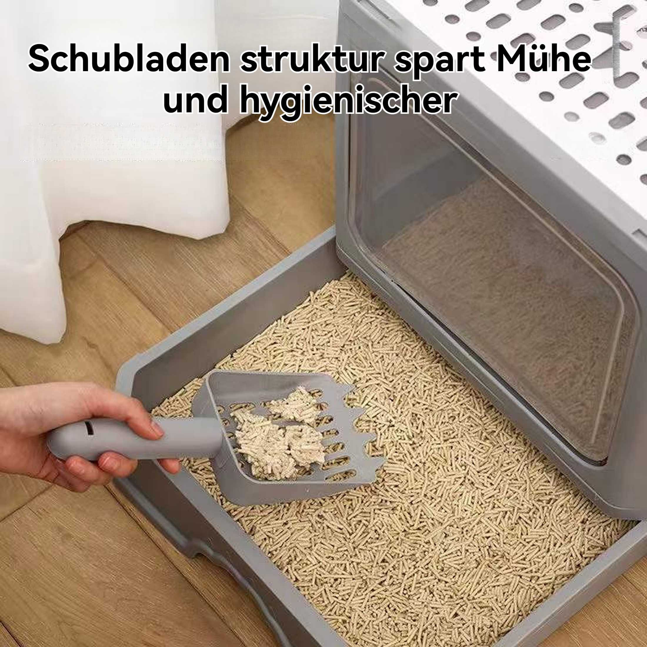 Hand schöpft Streu aus Katzentoilette. Box grau, Schubladenstruktur.
