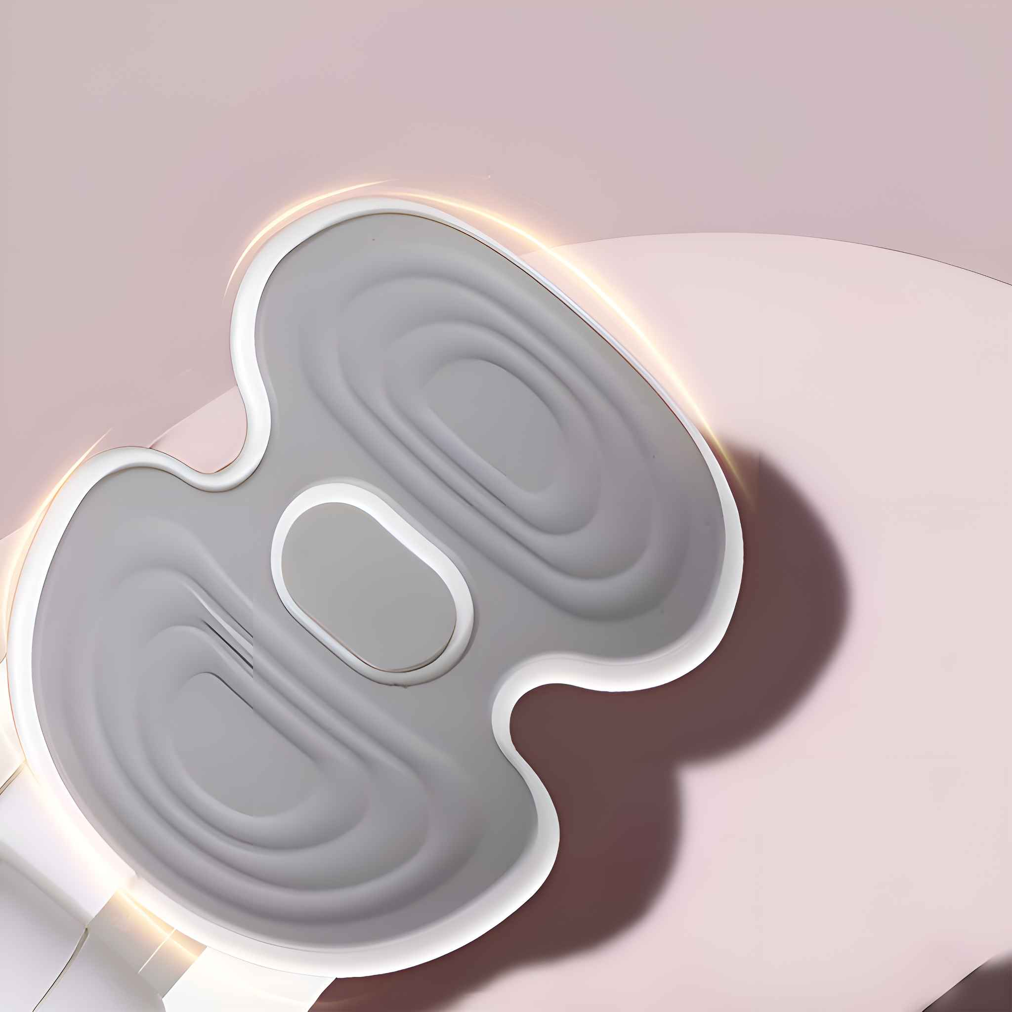 Ein graues Gerät mit weißem Rand auf rosa Hintergrund, mit einzigartiger Form und Design.