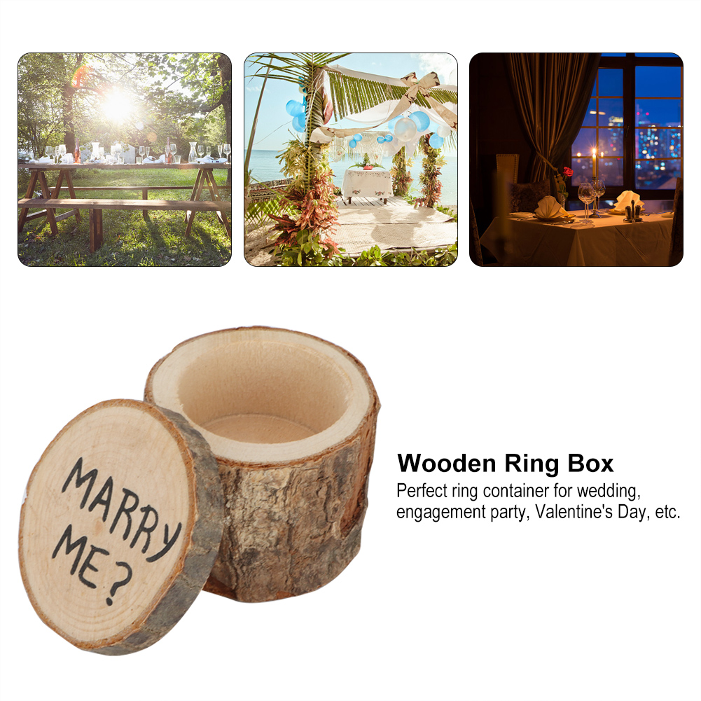Ein Bild zeigt eine hölzerne Ringbox mit offenem Deckel und dem Schriftzug 'MARRY ME?', mit Hochzeitsszenen.