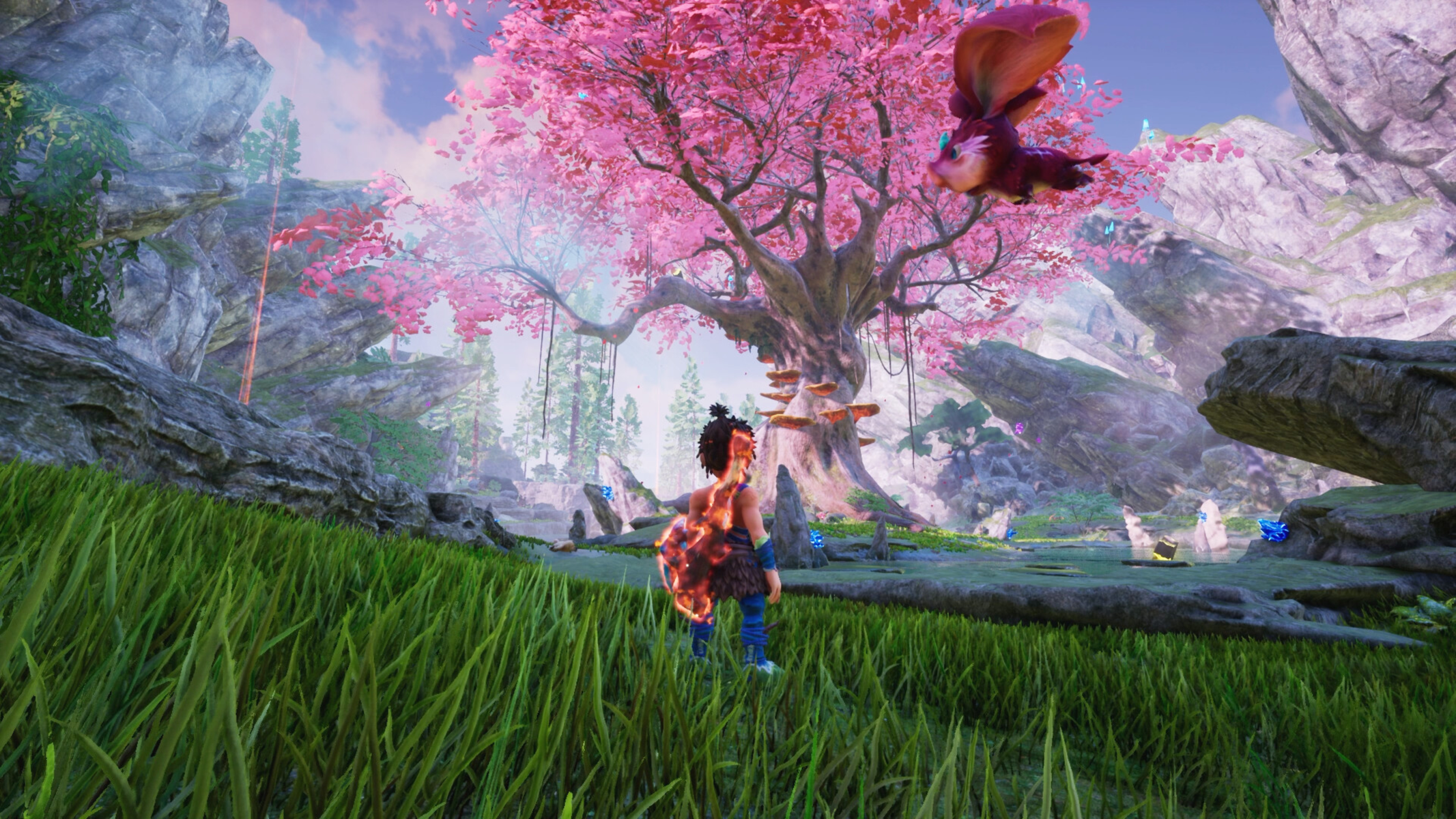 Postać stoi w bujnym krajobrazie fantasy, patrząc w górę na duże, różowe kwitnące drzewo i latające stworzenie.