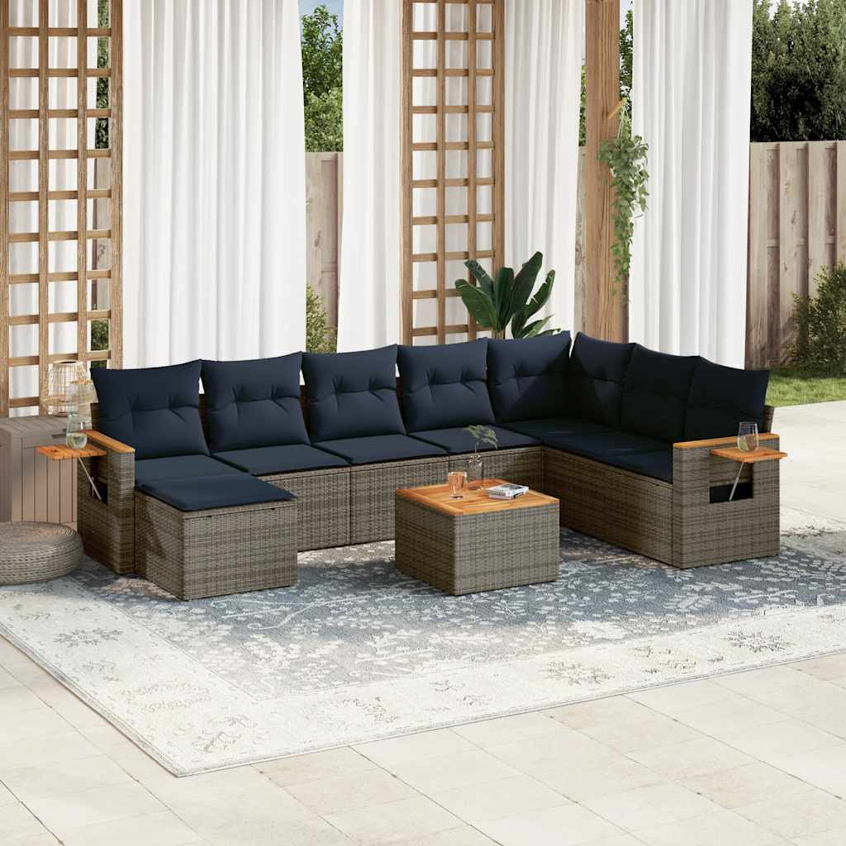 Ein Outdoor-Terrassenset. L-förmiges Sofa, kleiner Tisch und Teppich. Blaue Kissen und Vorhänge.