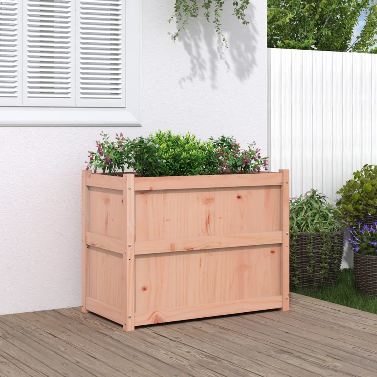 Holzpflanzkasten mit Pflanzen, hellbraun, auf einem Deck, in der Nähe einer weißen Wand.
