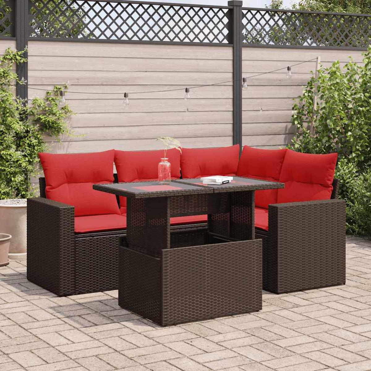 Braune Rattan-Gartenmöbel mit rotem Kissensofa und Tisch. Beinhaltet zwei Stühle mit roten Kissen.
