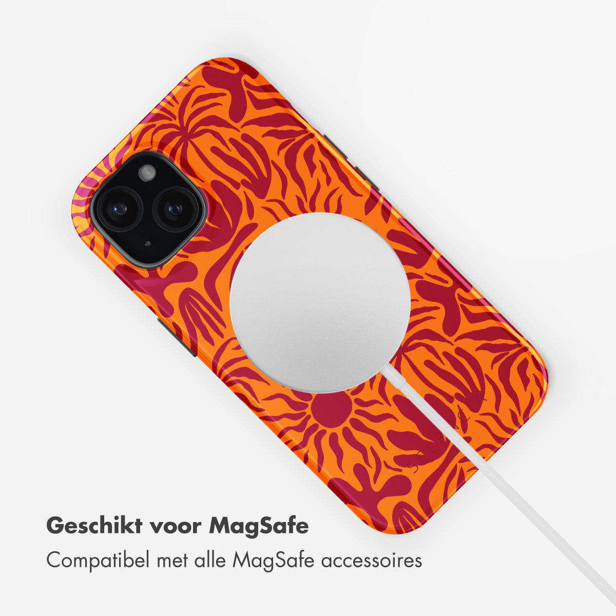 A phone with an orange and red floral MagSafe case and charger, on a white background.