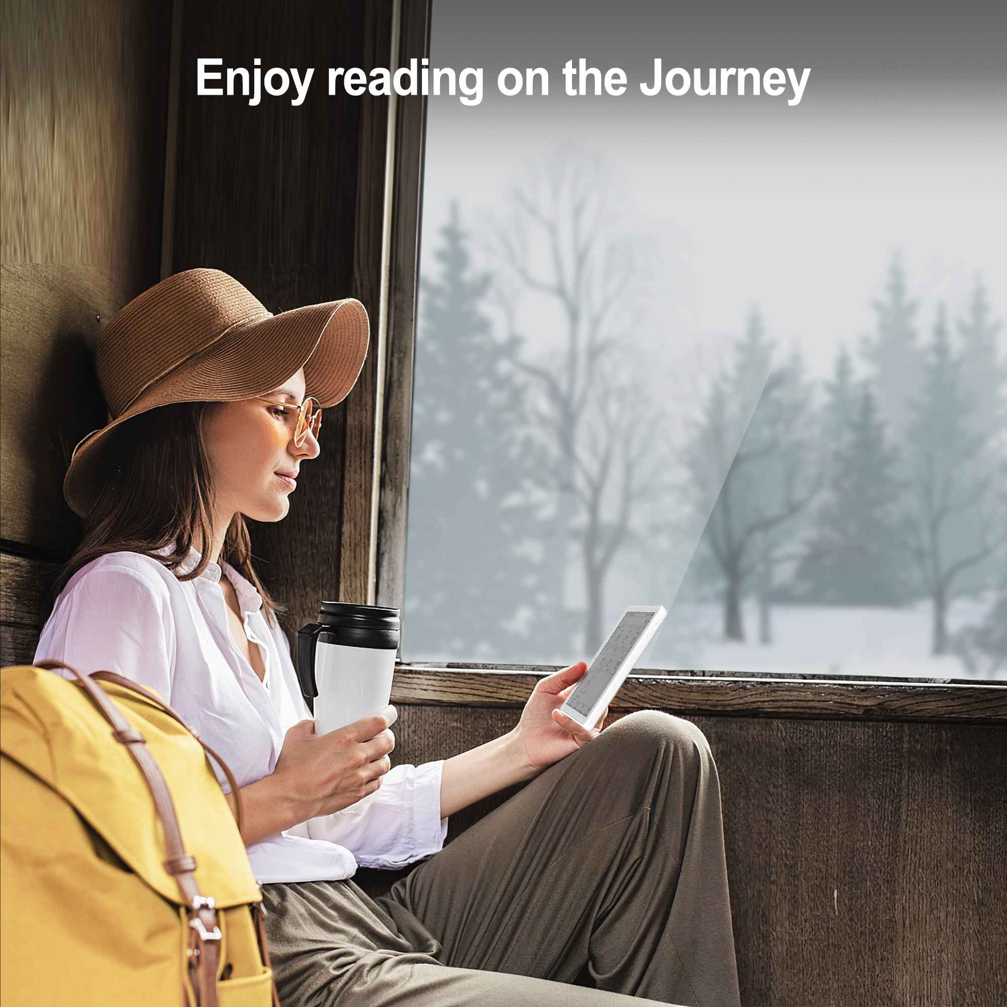 Eine Frau sitzt am Fenster, hält einen Becher und einen E-Book-Reader. Draußen ist Schnee zu sehen. Text sagt: Viel Spaß beim Lesen.
