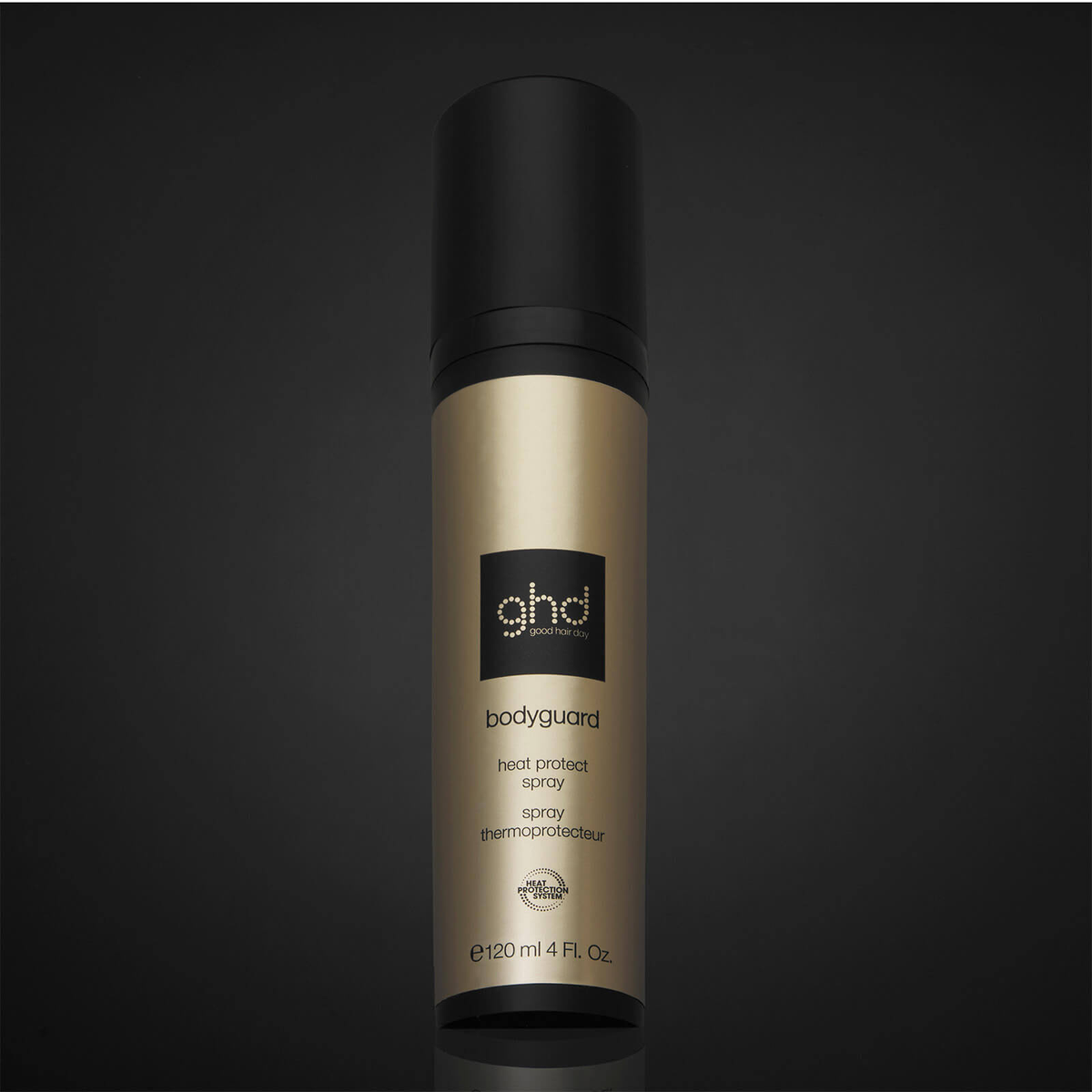 Una bomboletta nera e dorata di spray termoprotettore ghd Bodyguard su sfondo nero.