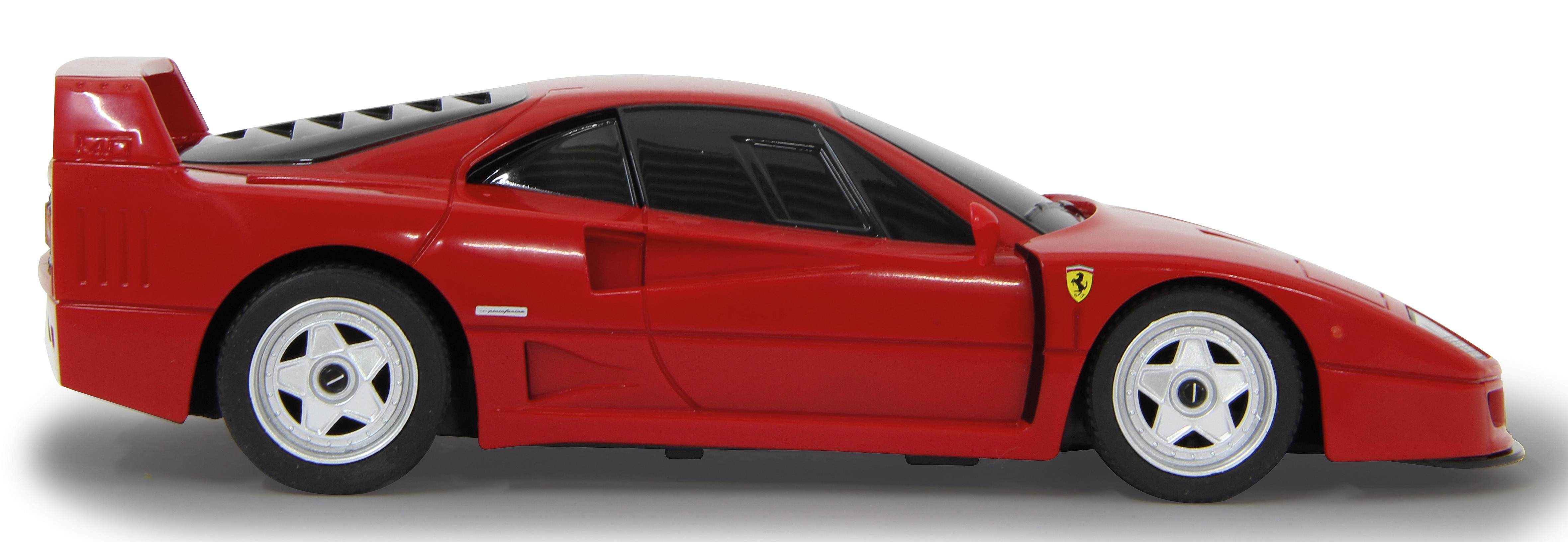 Rotes Ferrari F40 Spielzeugauto, Seitenansicht, auf weißem Hintergrund. Das Auto hat einen Heckflügel und schwarze Räder.