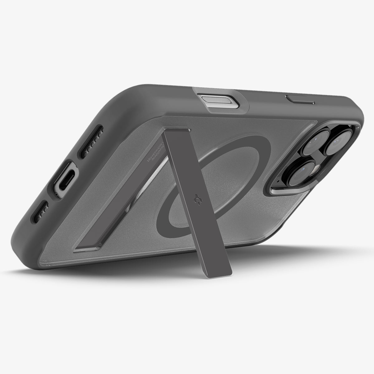 Grijze telefoonhoes, zijaanzicht met kickstand. De MagSafe-cirkel is aan de binnenkant zichtbaar.