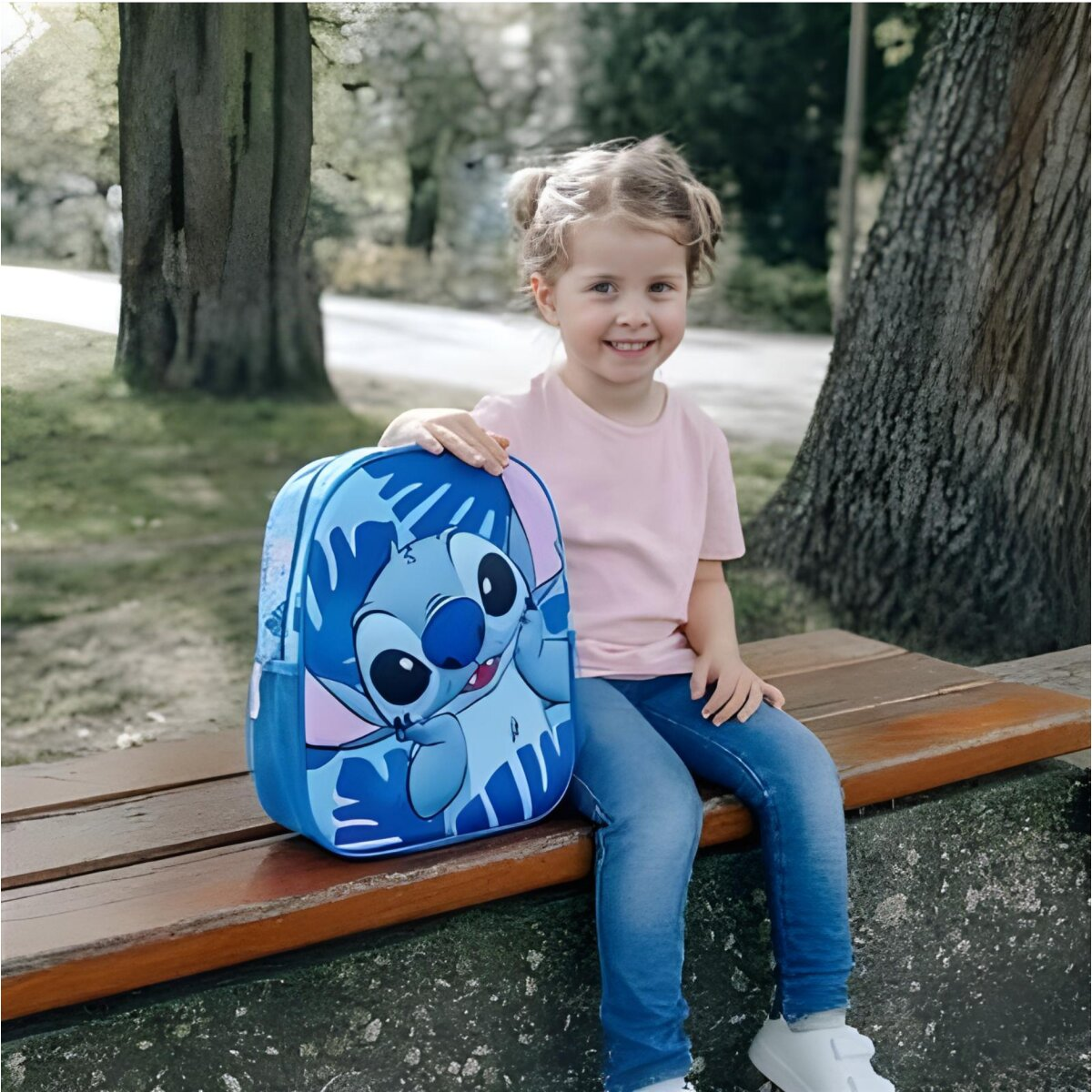 A girl sits on a bench with a Stitch backpack in a park setting.