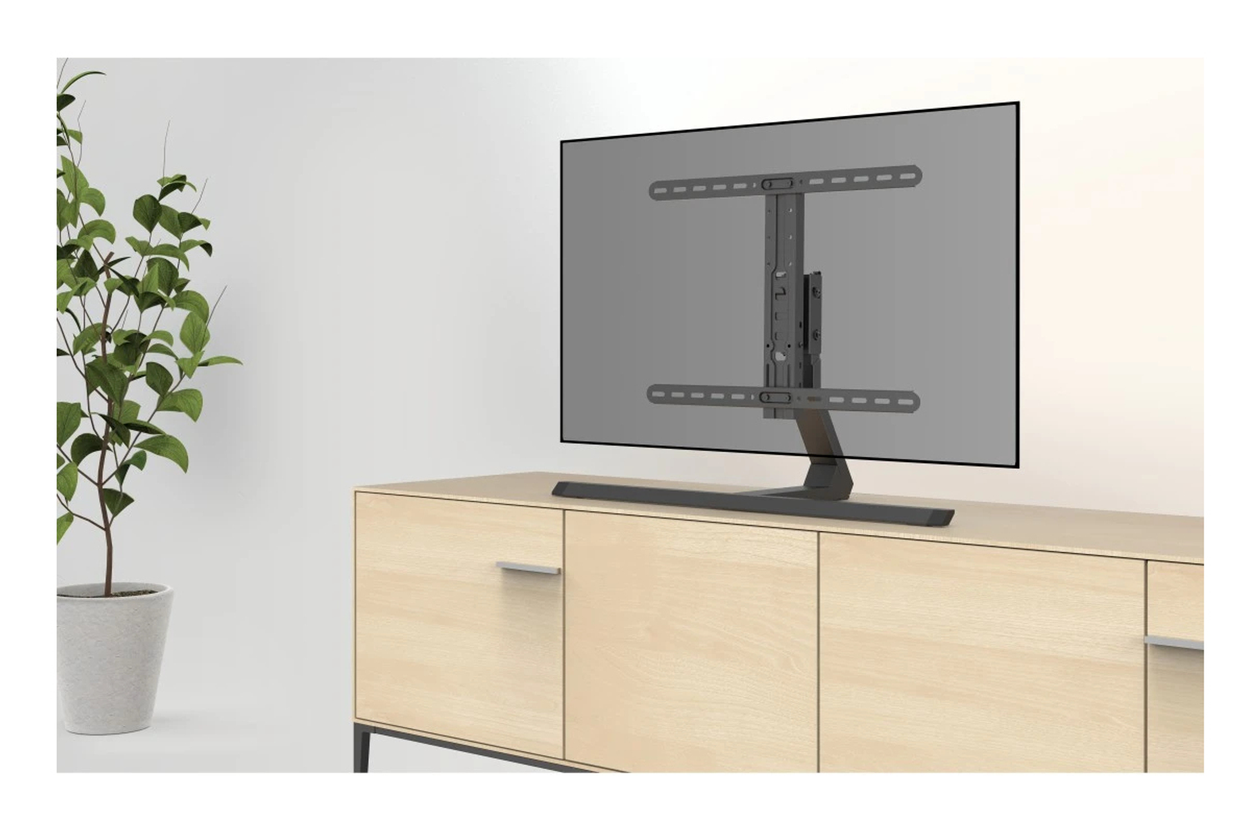 Un televisore è montato su una cassettiera in legno con una pianta sul lato.