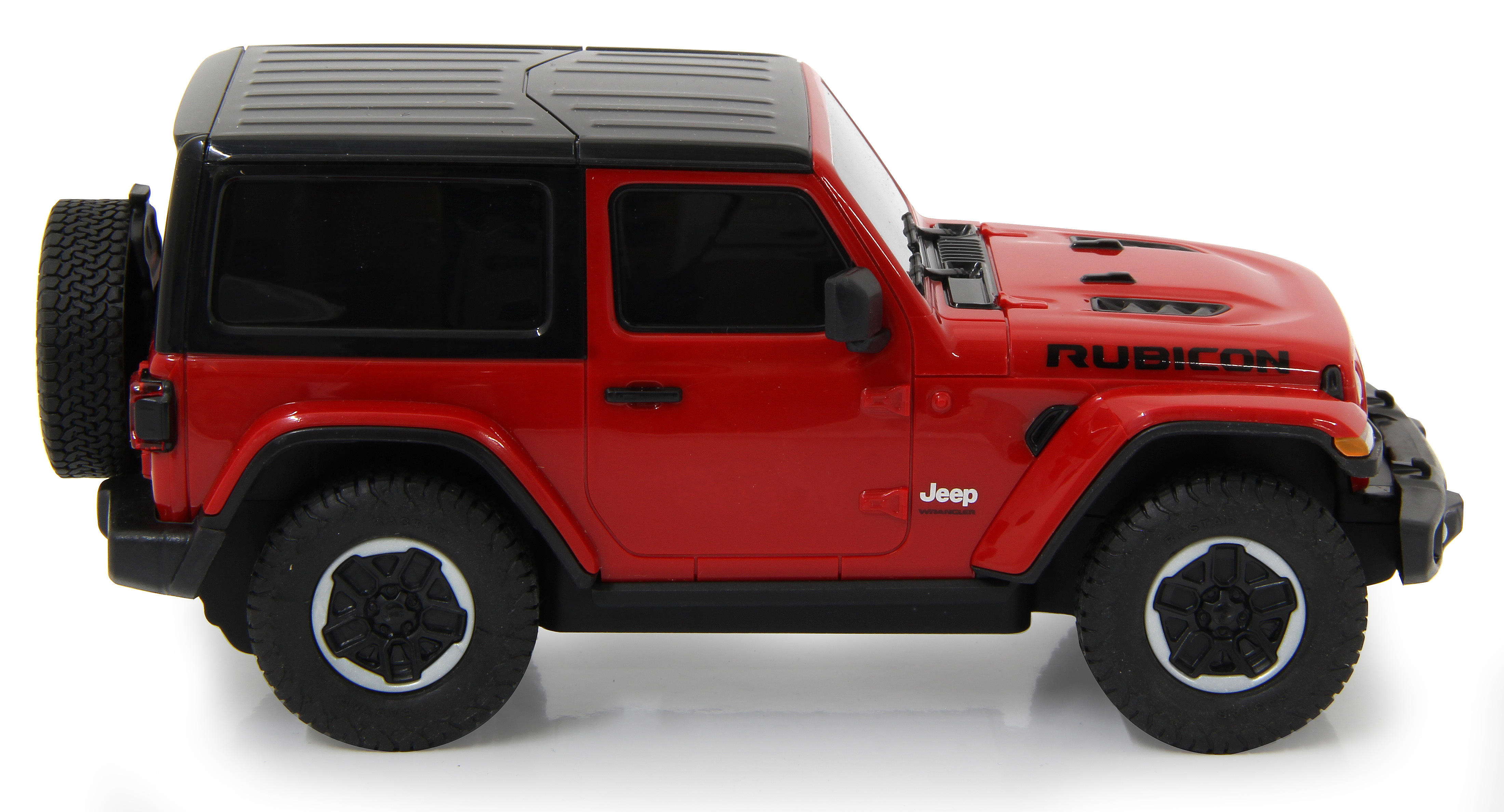 Ein rotes Jeep Rubicon Spielzeugauto mit schwarzem Dach, von der Seite betrachtet. Das Ersatzrad ist sichtbar.