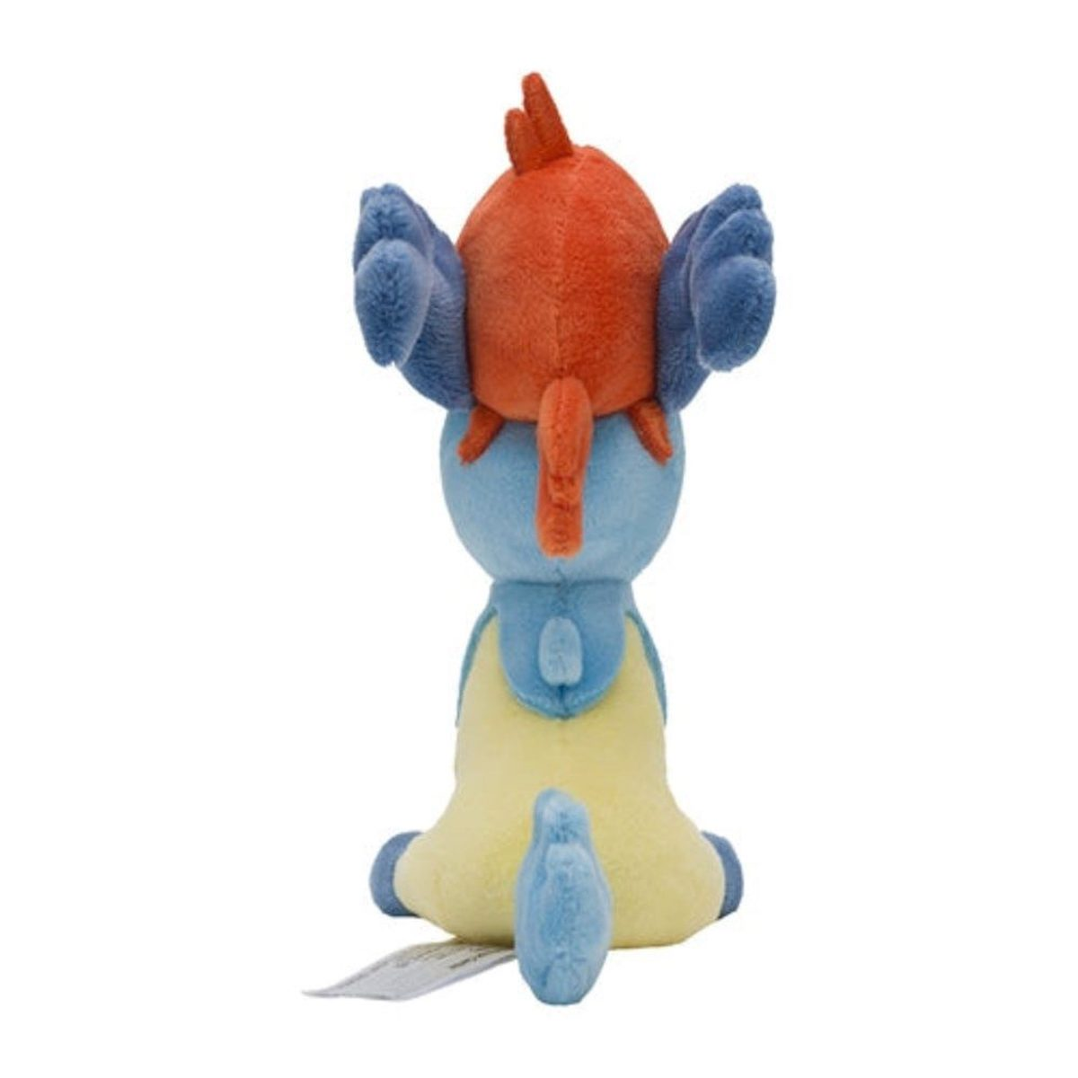 Ein Plüschtier einer gelb-blauen Kreatur mit orangefarbenem Kopfschmuck und blauen Ohren, von hinten.