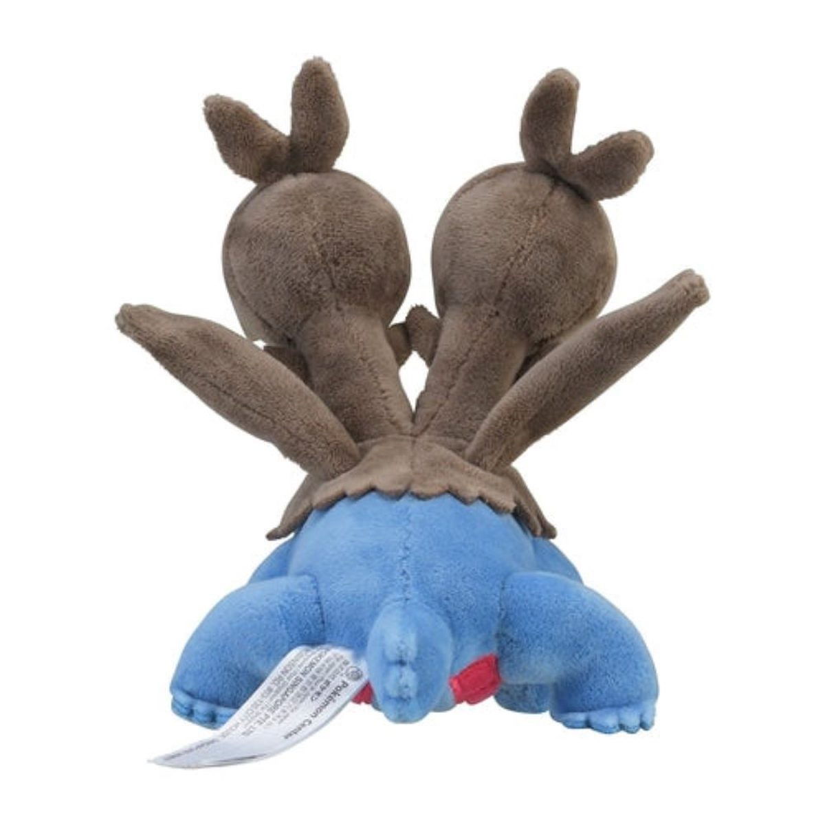 Ein Plüschtier in Form eines zweiköpfigen Wesens mit braunen Köpfen auf einem blauen Körper. Ein Etikett ist sichtbar.