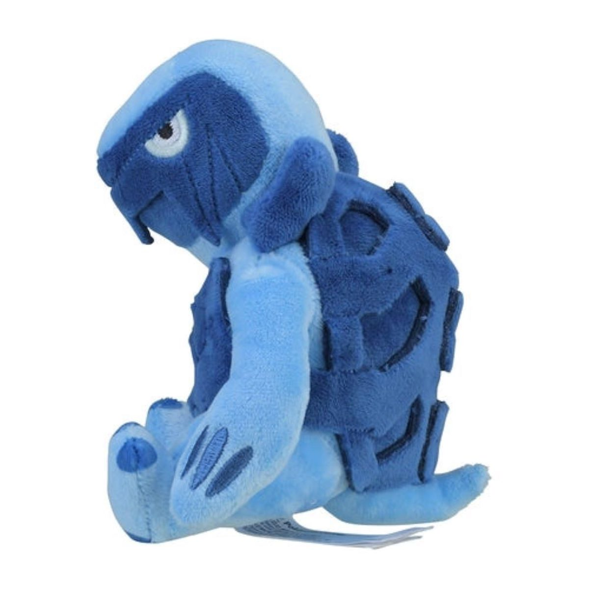 Ein blaues Plüschtier mit schildkrötenartigem Panzer und einem wütenden Gesichtsausdruck.