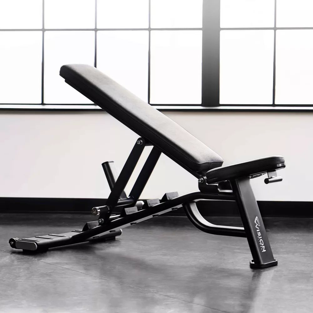 An adjustable workout bench in a gym setting, positioned near a window.