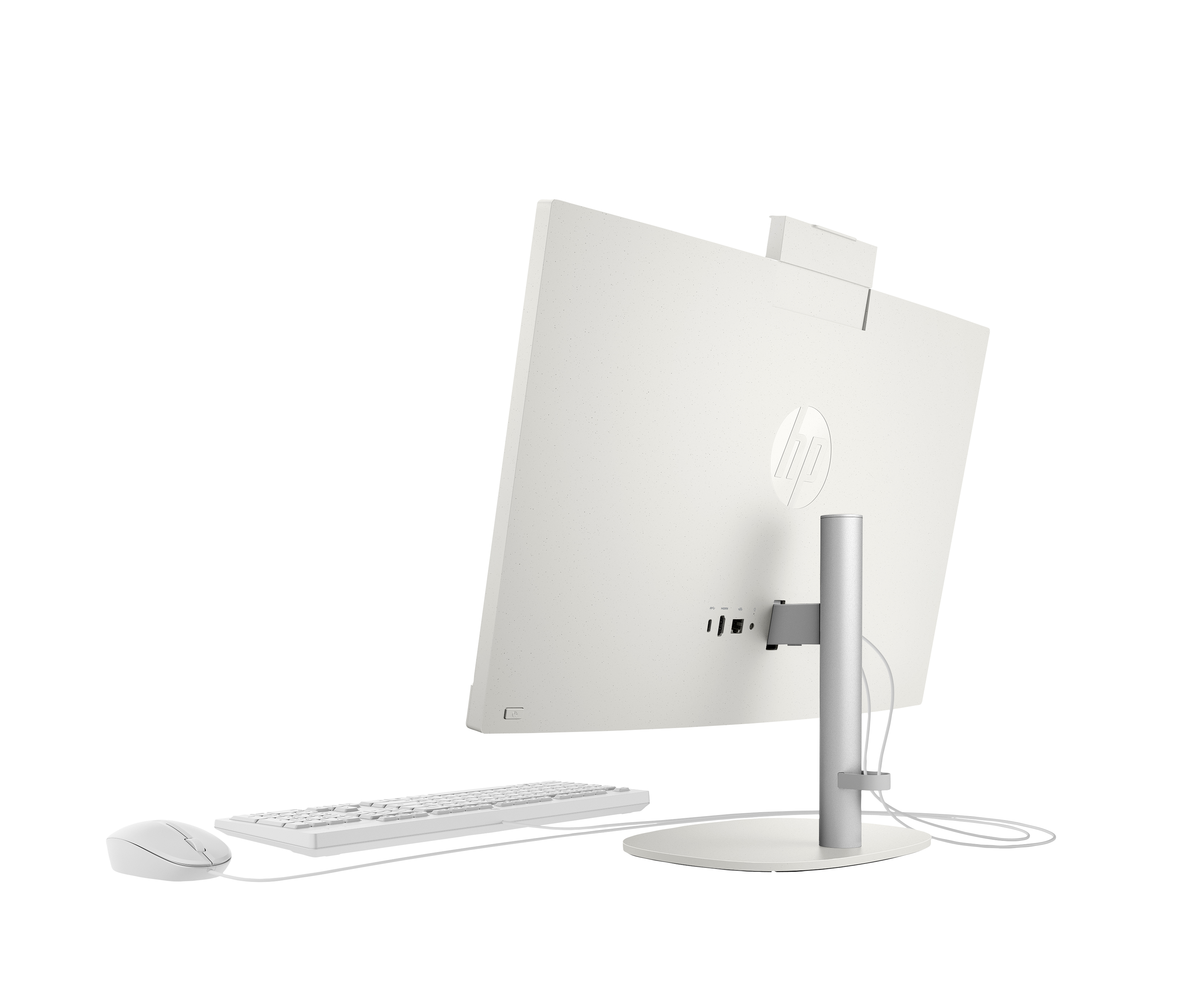 Tył białego komputera All-in-One. Klawiatura i mysz znajdują się przed ekranem.