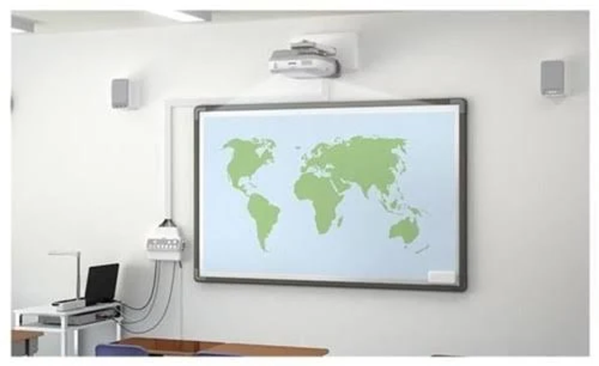Classroom setup with a whiteboard displaying a world map, projector, speakers, and laptop.