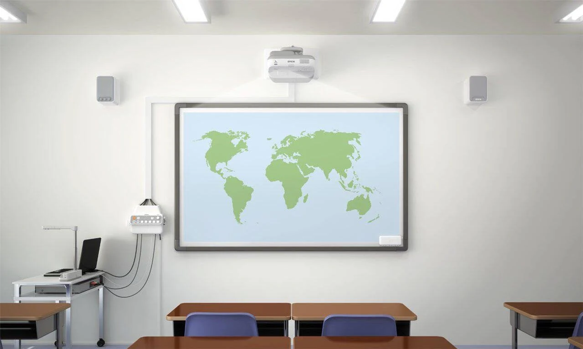 A classroom with a world map on the whiteboard, a projector, speakers, desks, and chairs.