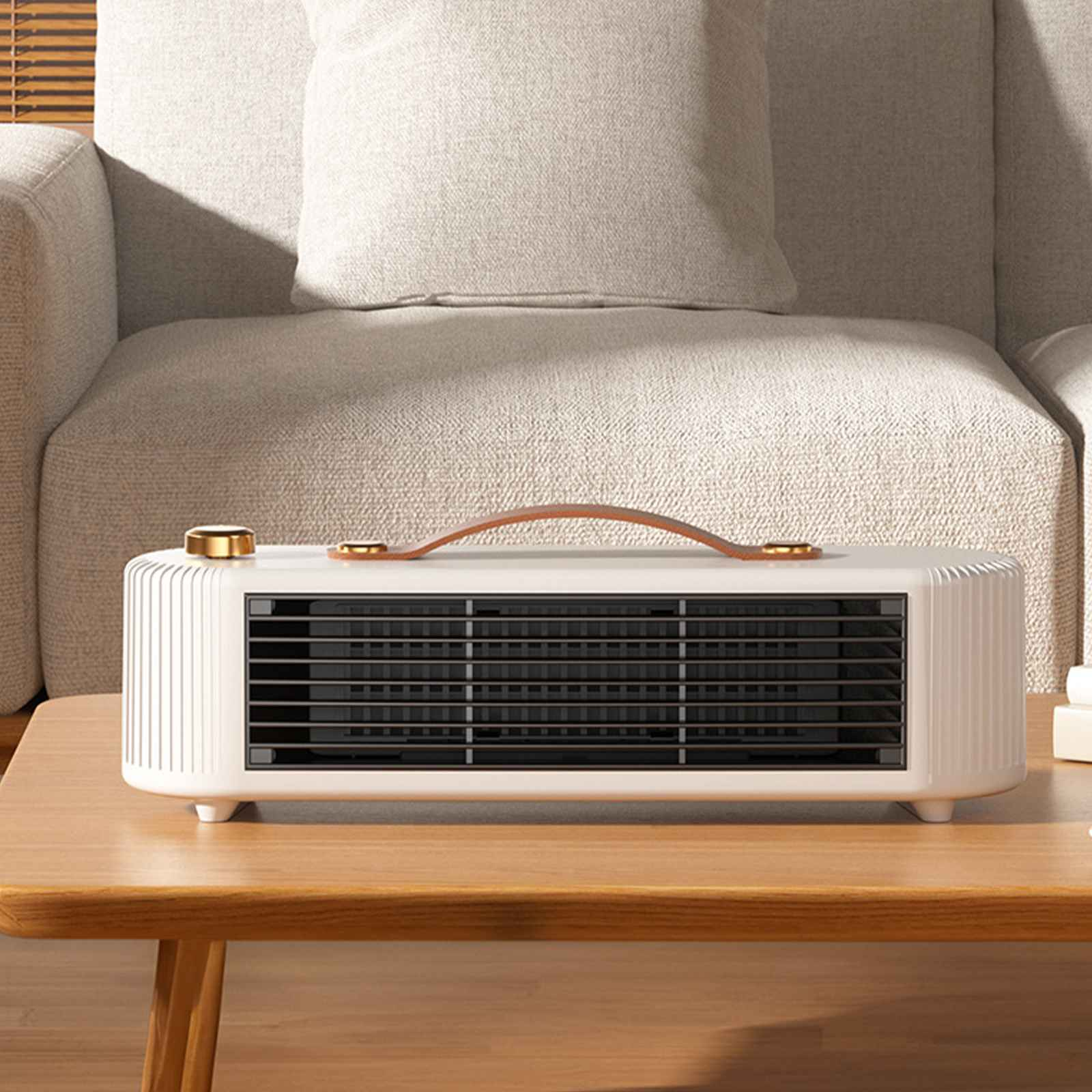 Eine weiße und beige Elektroheizung auf einem Holztisch. Die Oberseite hat einen Griff und einen schwarzen Grill.