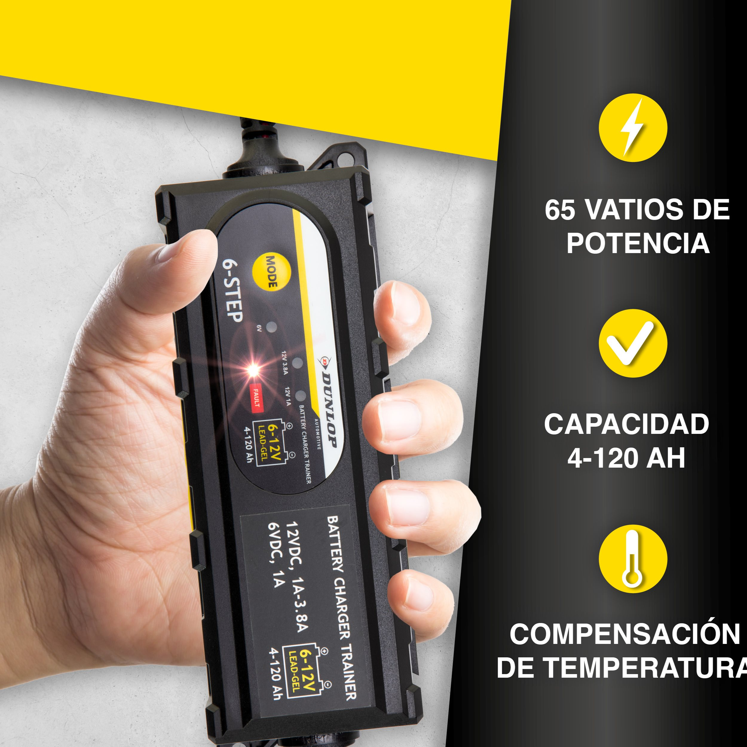 A hand holds a black battery charger with text in Spanish. The charger has lights and a yellow background.