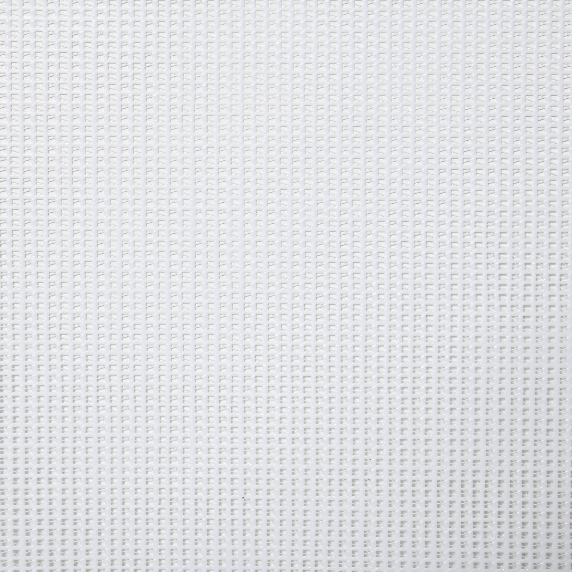 Primer plano de una tela blanca texturizada. La textura tiene un patrón de rejilla. La tela está uniformemente iluminada.