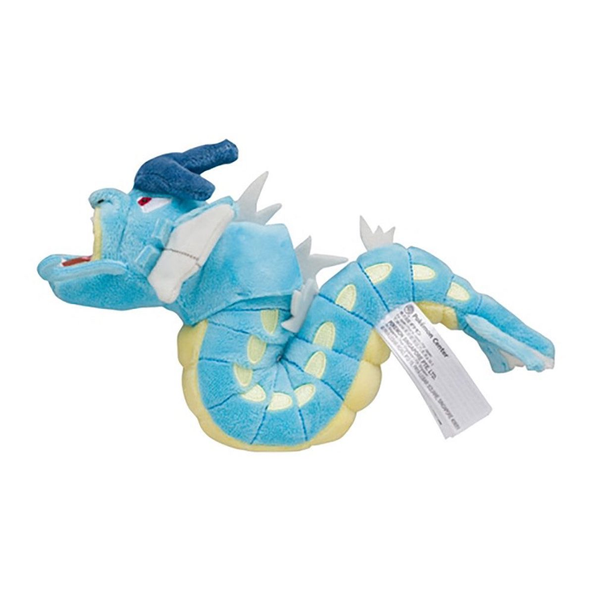 Ein blaues Gyarados-Plüschtier mit weißen Akzenten und einem Etikett. Es liegt auf weißem Hintergrund.